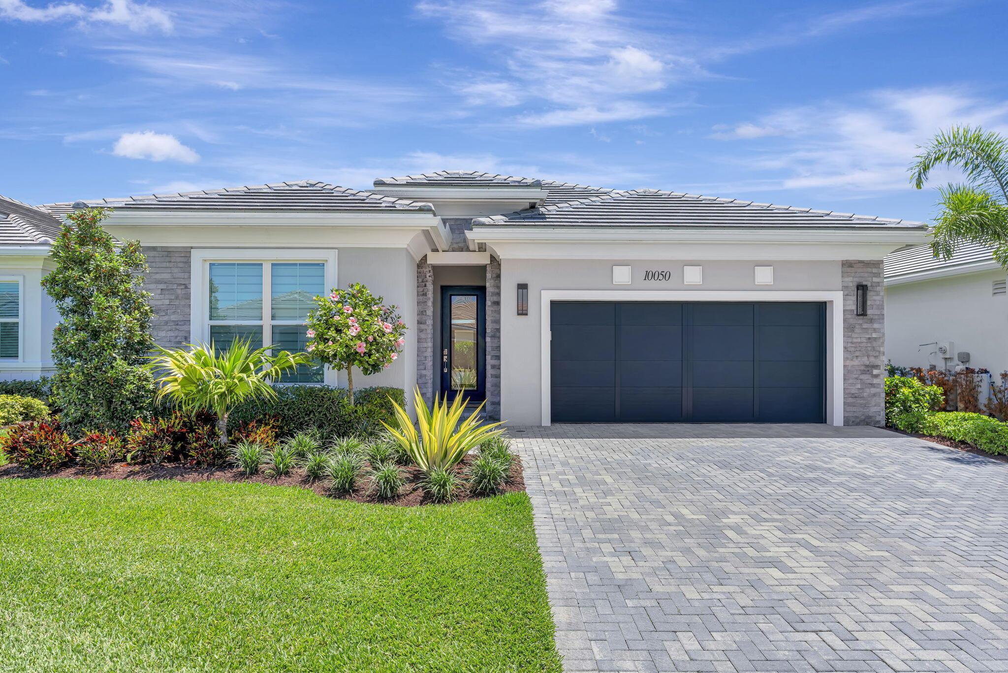 This McKenna is a beautiful home with a Contemporary elevation with a veneer stone exterior.  As you enter, you're welcomed by a coffered foyer ceiling with high ceilings throughout the main house. Expanded kitchen with butler pantry and quartz countertops.  Double stack cabinets with glass cabinets on the top which light up. Outside is an amazing private backyard with a lanai with electric screens, and a heated in ground pool. Window treatments are Hunter Douglas. Toto Bidet in primary bath. Closet Factory walk in closets in primary bedroom, pantry, and bonus storage space. Fixtures and fans included. Hook up for outdoor kitchen is installed. Completely move in ready with many upgrdes.  Don't miss this gem!