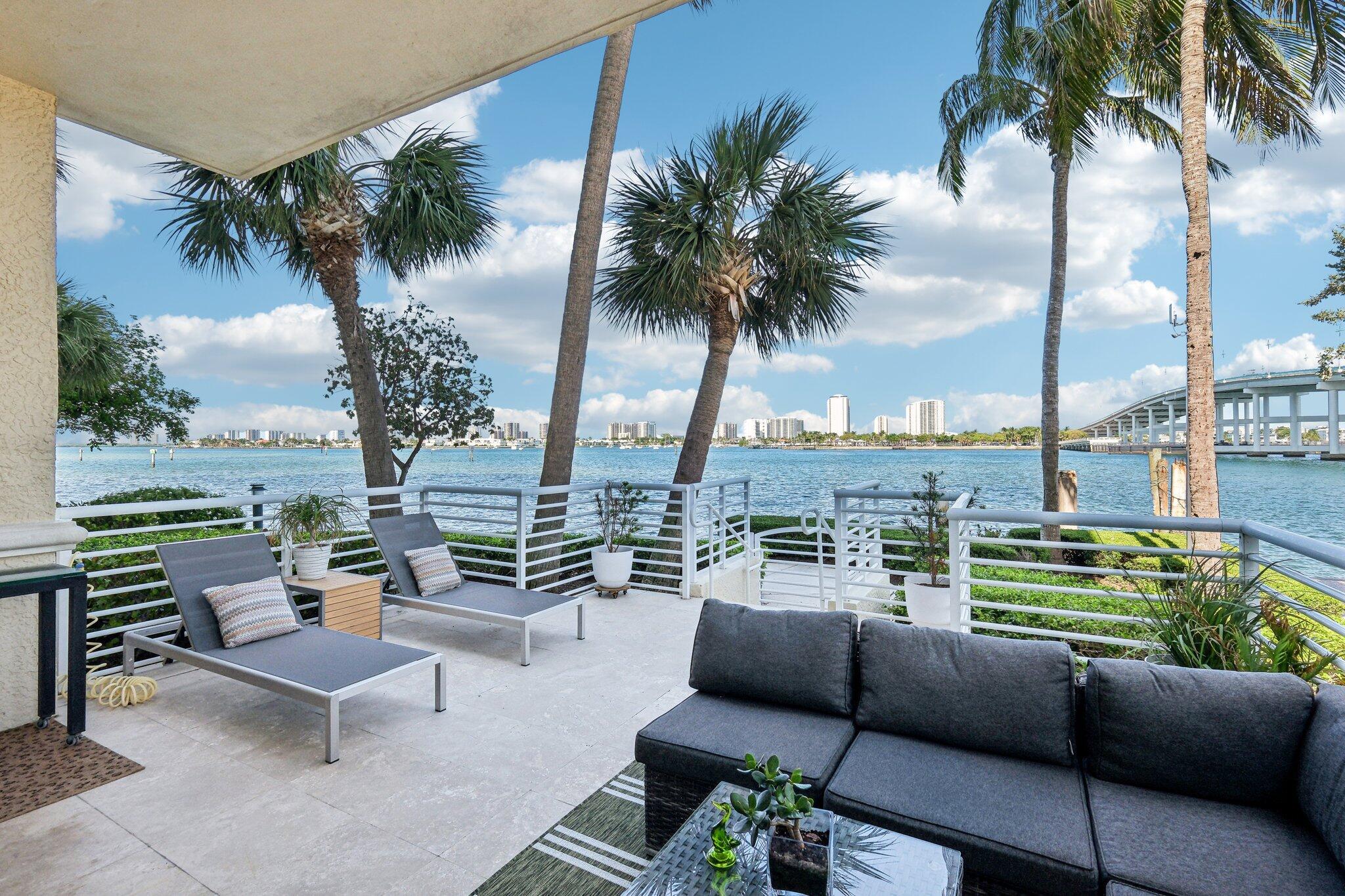 Discover a rare opportunity to own an exceptional first-floor turnkey designer residence in a private corner location, offered at $879,000. This beautifully updated 3-bedroom, 3-bathroom home (with the third bedroom converted to a den for a flexible work-from-home lifestyle) features soaring 10.5-foot ceilings, 8-foot solid interior doors with Emtek hardware, 10-foot impact sliding doors, and larger impact windows in the master bedroom, along with an expansive travertine patio that opens directly to the wide, blue Intracoastal Waterway--ideal for entertaining or relaxing without the need for elevators. (private hose bib for rinsing off) Interior highlights include white oak custom cabinetry by Unique Custom Cabinetry (2024), a built-in bar, bookshelves, and credenza, a contemporary kitchen with 36-inch upper cabinets, Cristallo Bianco quartz countertops and backsplash, newer appliances, honed 18x18 travertine marble floors throughout (no carpet), crown molding, custom closet organizers, -+-inch frameless glass shower doors, designer lighting and wall coverings, custom roller shades and curtains, and advanced lighting controls by Leviton and Brilliant. The newly remodeled amenities include a fitness center, sauna, steam room, community room, 4 pickleball courts, tennis court, bocce ball, card room, heated pool area with grills, billiard room, full-service valet, 24-hour security, on-site management, bike storage, additional storage cage, building ins., water, cable &amp; internet. Enjoy walkable access to Publix and a full-service marina right next door. Listing agent will attend all showings to provide a personalized and thorough experience&#x14;this exceptional property won't last once active.