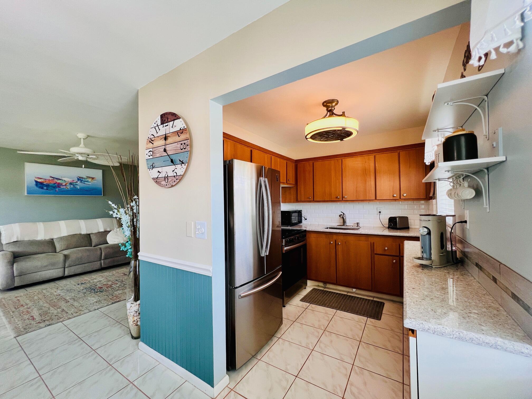 MOVE IN READY & UPDATED IN 55+ CENTURY VILLAGE! Meticulously Maintained CORNER 2/1.5. Pretty Updated Kitchen With Window for Natural Light, Wood Tone Cabinets, Stainless Appliances, and Extra Cabinets & Counter Space. Updated Baths: Full Bath Features a Step-in Shower. Living Area Features Neutral Tile Flooring & Popcorn Removed from the Ceiling. Long Enclosed Lanai with Tile Flooring. Hurricane Impact Windows & Front Door. Convenient Location Close to the Haverhill Gate, Main Clubhouse, and Somerset Pool. Well Maintained Building With Lift and Metal Roof (2020). Sold Furnished As Shown With Tasteful Furnishings (personal items excluded). Century Village Is a Resort Style 55+ Community With So Much to Offer...