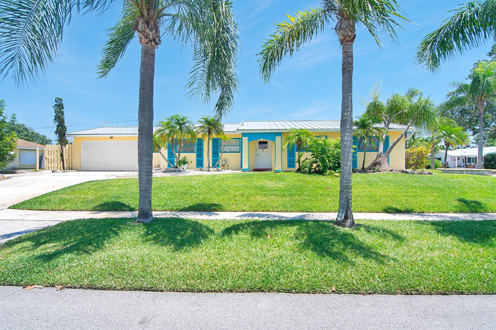 Welcome to this home situated in the heart of Tequesta. This 2 bedroom/2 bath home features a roof installed in 2024, AC in 2024, exterior painted in 2024 and interior freshly painted in 2025. Nestled on a high and dry, corner lot this home has a fenced yard and a private pool. The 2 car garage has a new beltless garage door,2025, and a  rear door large enough for a boat to be parked in the additional space in the rear of the home. The spacious interior is all tile, no carpet and the two bedroom suited both have bathrooms ensuite. Located in highly desirable Tequesta this home is waiting for you to update this home and make it yours. Located close to the Loxahatchee River and several beaches, along with vibrant local amenities and restaurants.
