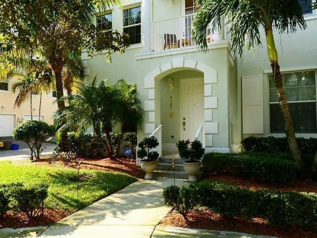 END UNIT  TOWN HOME, DARKWOOD FLOORS THROUGHOUT,KITCHEN WITH GRANITE , 42'' CABINETS PULL OUTS AND BREAKFAST BAR AND FORMAL DINING AREA. THIS HOME FEATURES 2 MASTER SUITES!! MASTER DOWNSTAIRS IS 20X15,FULL BATH AND WALK IN CLOSET. GREAT FOR HOME BASE BUSINESS!! 2ND MASTER SUITE ALSO HAS FULL BATH AND WALKIN W/ADDITIONAL EN COVE FOR OFFICE AREA AND TRAY CEILING. BEDROOMS 3 & 4 ARE LOCATED ON SAME FLOOR W/OVERSIZED CLOSETS AND BRAND NEW CEILING FANS AND A SHARED FULL BATH.. FIRST FLOOR HAS A BONUS ROOM THAT COULD BE USED AS AN OFFICE AREA OR PLAYROOM FOR THE KIDS! LIVING AREA ON 2ND FLOOR IS VERY SPACIOUS W/ BAY WINDOW AND BALCONY OVERLOOKING GREEN AREA W/GAZEBO. BOTH MASTERS HAVE INTERCOM SYSTEM AND LIVING AREA HAS MASTER INTERCOM ENTERTAINMENT SYSTEM THAT CAN BE PLAYED THROUGHOUT THE HOME. LAUNDERY/UTILITY ROOM .ALARM SYSTEM W/MOTION DETECTOR. . CUSTOM LIGHTING IN KITCHEN, DINING AND STAIRCASE. HIGH HAT LIGHTNG THROUGHOUT WITH DIMMERS. FULL SIZE 2 CAR GARAGE AND AUTO GARAGE. PLENTY OF PARKING FOR THIS UNIT TOO! A RATED SCHOOLS,WALK TO ROGER DEAN STADIUM,TOWNE CENTER,SKATE PARK,FAU AND SCRIPPS CENTER. CLOSE TO 95 AND TURNPIKE FOR EASY COMMUTING. CLOSE TO GARDENS MALL,DOWNTOWN AND MIDTOWN GARDENS. MINUTES FROM THE BEAUTIFUL BEACH!! DON'T MISS OUT ON THIS HOME IT HAS EVERYTHING TO OFFER
