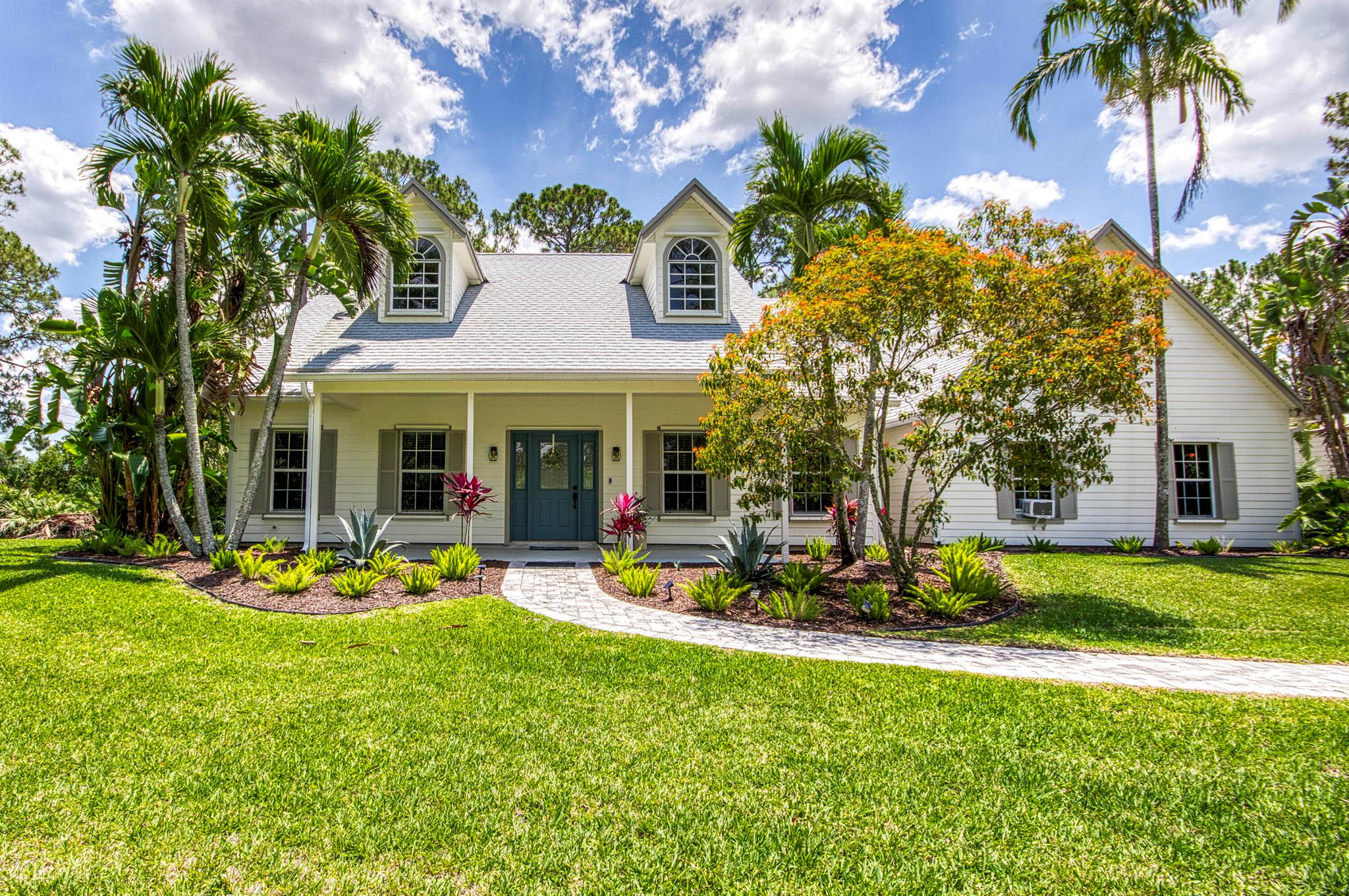 This charming, Farmhouse inspired Loxahatchee home sits on 1.37 private acres and is packed with upgrades for comfort and peace of mind. Highlights include a 2024 roof, impact-rated garage door, updated bathrooms, 2024 light fixtures, 2025 refrigerator and washer, 2021-2022 oven/stove, 2022 air handler, 2018 condenser, and 2021 water heater. The kitchen features real wood cabinets and granite counters. A generator hookup is installed in the panel, and the seller is leaving the generator, it can run the home during outages, as long as you're not cooking inside.