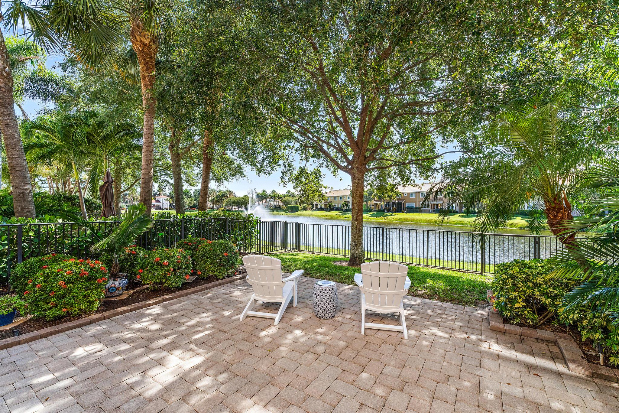 Rarely Available Lakefront End Unit Townhome in Paloma with Private Fenced Yard. Where else can you find a townhome with its own private, fenced backyard overlooking a peaceful lake--plus the added space and light of an end unit--all within a gated, amenity-rich community? This beautifully updated 3-bedroom, 2.5-bath townhome in Paloma truly stands out. Enjoy a recently redesigned kitchen with 42'' soft-close wood cabinetry, quartz countertops, and a marble backsplash. The home features engineered wood flooring throughout, including the stairs, upgraded recessed lighting, and full impact glass protection for safety and efficiency. Upstairs, in addition to the spacious bedrooms, you'll find a versatile loft area--perfect for a home office, playroom, or second living space. The primary suite offers serene lake views and a relaxing retreat.

Paloma residents enjoy access to a resort-style community pool, and the reasonable HOA fees include gated security, cable, internet, water, and lawn maintenance.

Ideally located near The Gardens Mall, Downtown at the Gardens, and a wide selection of restaurants, with Palm Beach International Airport (PBIA) just 15 minutes away.

This is a rare opportunity to enjoy lakefront, end-unit living with added privacy, natural light, and flexible space&#x14;all in one of Palm Beach Gardens' most desirable communities.