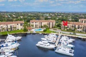 Enjoy stunning views and tropical breezes from this spacious 2BR/2BA condo overlooking the Bluffs Marina. Features include a large living area with two seating spaces, breakfast bar, dining area, and a versatile bonus/laundry room--great for storage, office, or guests. The community offers four pools with covered pavilions, resurfaced tennis/pickle ball courts, and lush, tropical landscaping. Winding sidewalks lead to the beach and are perfect for walking or biking. Just minutes from Jupiter beaches, Juno Pier, Harborside, and top dining and nightlife.