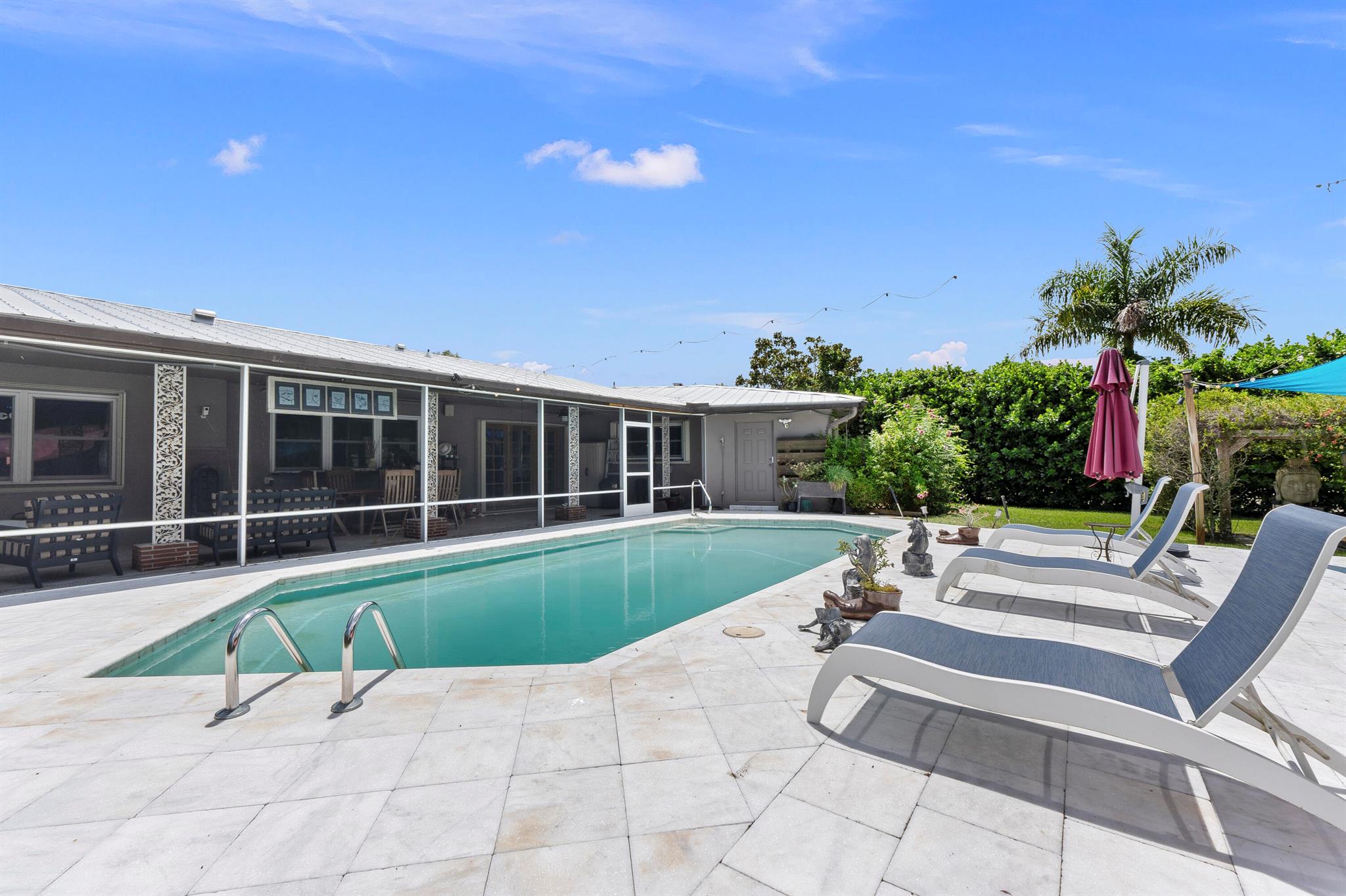 Welcome to space, style, and sustainability. This 4-bedroom home with a flex room/office sits on .85 of an acre and offers 4,152 sq ft of living space. Features include concrete block construction, a 2019 metal roof, and full solar power--averaging just $27/month in electric costs. Enjoy a Sub-Zero fridge, induction cooktop, and EV-ready garage. Fenced yard with pool for entertaining. A smart, stylish home with an unbeatable price per square foot--ready for your next chapter.