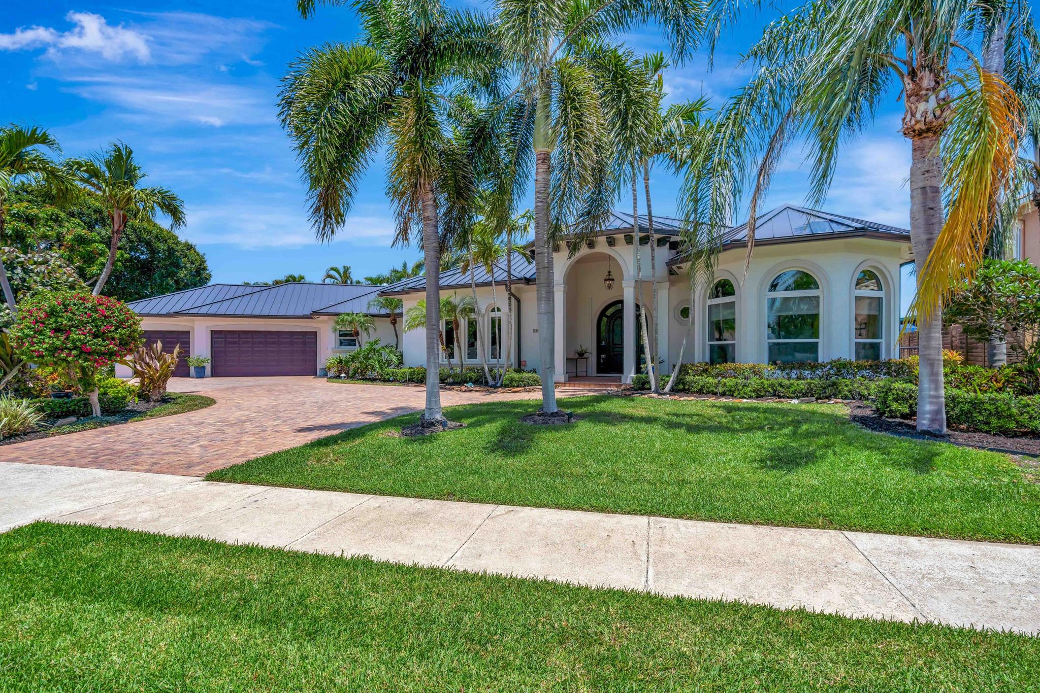 Coastal living at its finest in the heart of North Palm Beach! This waterfront gem offers canal and downwater Intracoastal views, direct ocean access, and a vibe that's equal parts laid-back luxury and custom-crafted style. With 4 bedrooms, 4 full baths, and a floor plan designed for everyday comfort and unforgettable entertaining, this home is truly one-of-a-kind. Inside, you'll find a gourmet kitchen with custom wood cabinetry, a walk-in pantry, and an adjacent formal dining room perfect for hosting friends and family. The spacious primary suite features his-and-hers closets, plus private access to the tropical backyard and pool. The spa-like bathroom is a showstopper with a freestanding soaking tub, double marble shower, and direct outdoor access for that true resort feel. There's plenty room to spread out with a dedicated billiards, wine, and entertainment room, and a stunning living area centered around a gas fireplace framed in coquina stone and polished porcelain tile.
Step outside and your private paradise awaits lush landscaping, a saltwater freeform pool, spillover heated spa, and your own dock with 13,000 lb elevator boat lift (accomodates up to 34' boat)  Fire up the built-in grill and griddle in the summer kitchen, grab a seat at the outdoor bar, and kick back under the expansive covered lanai with whitewashed tongue-and-groove ceilings for that breezy coastal charm. And don't forget the oversized 3-car garage with epoxy floors&#x14;because every detail here is dialed in. Whether you're boating, hosting, or simply relaxing poolside, this home delivers the ultimate Florida lifestyle stylish, unique, and ready for you. 
The Village of North Palm Beach features several beautiful parks, such as Anchorage Park, with playgrounds, docks, volleyball courts, tennis courts, and a dog park. The Village is also home for the newly renovated North Palm Beach Country Club, featuring an Olympic swimming pool, splash pad, picnic area, an on-deck tiki hut, 200 seat banquet room, fine dining at The Grill and The Clubhouse restaurants,  A Jack Nicklaus Signature Golf Course, and a full featured Tennis Facility with Har-Tru courts. Close to beaches, recreation, dining and entertainment. Easy access to major highways and Palm Beach International Airport.