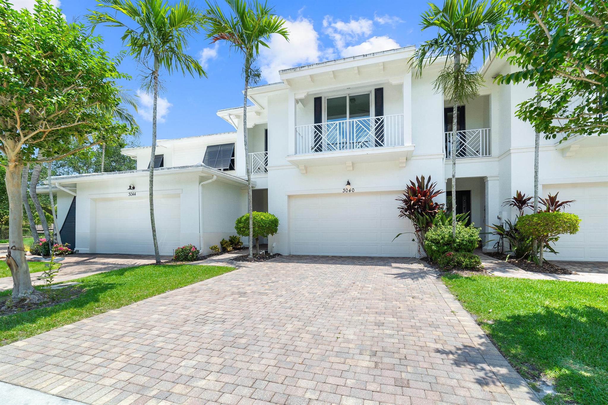 Upgraded Former Builder's Model in Highly Desirable Hampton Cay. Located in the heart of Palm Beach Gardens, this model home is located in a boutique gated community with A-rated schools. The home features white marble floors, custom wall and ceiling accents, and an open layout. The kitchen is equipped with stainless steel appliances, a tile backsplash, and upgraded cabinetry. The primary suite offers California Closets-designed walk-ins, a spa-style bathroom, and a private balcony with lake views. Two additional bedrooms have new carpet (2025), and the full laundry room includes a washer, dryer, and utility tub. Recent updates include a new A/C (2024), garage door (2023), dishwasher, oven and stove top are brand new (never been used) (2025), interior paint (2025), and bedroom carpet (2025). Enjoy outdoor living with a paver patio overlooking the lake, a covered main-level patio, and two covered balconies. A paver driveway and two-car garage add convenience. Hampton Cay offers a 6,000-square-foot clubhouse, heated infinity pool, spa, fitness center, game room, and billiards room all within minutes of I-95, the Turnpike, shopping, dining, and golf. This move-in ready home combines modern comfort with unbeatable location and top-tier amenities.