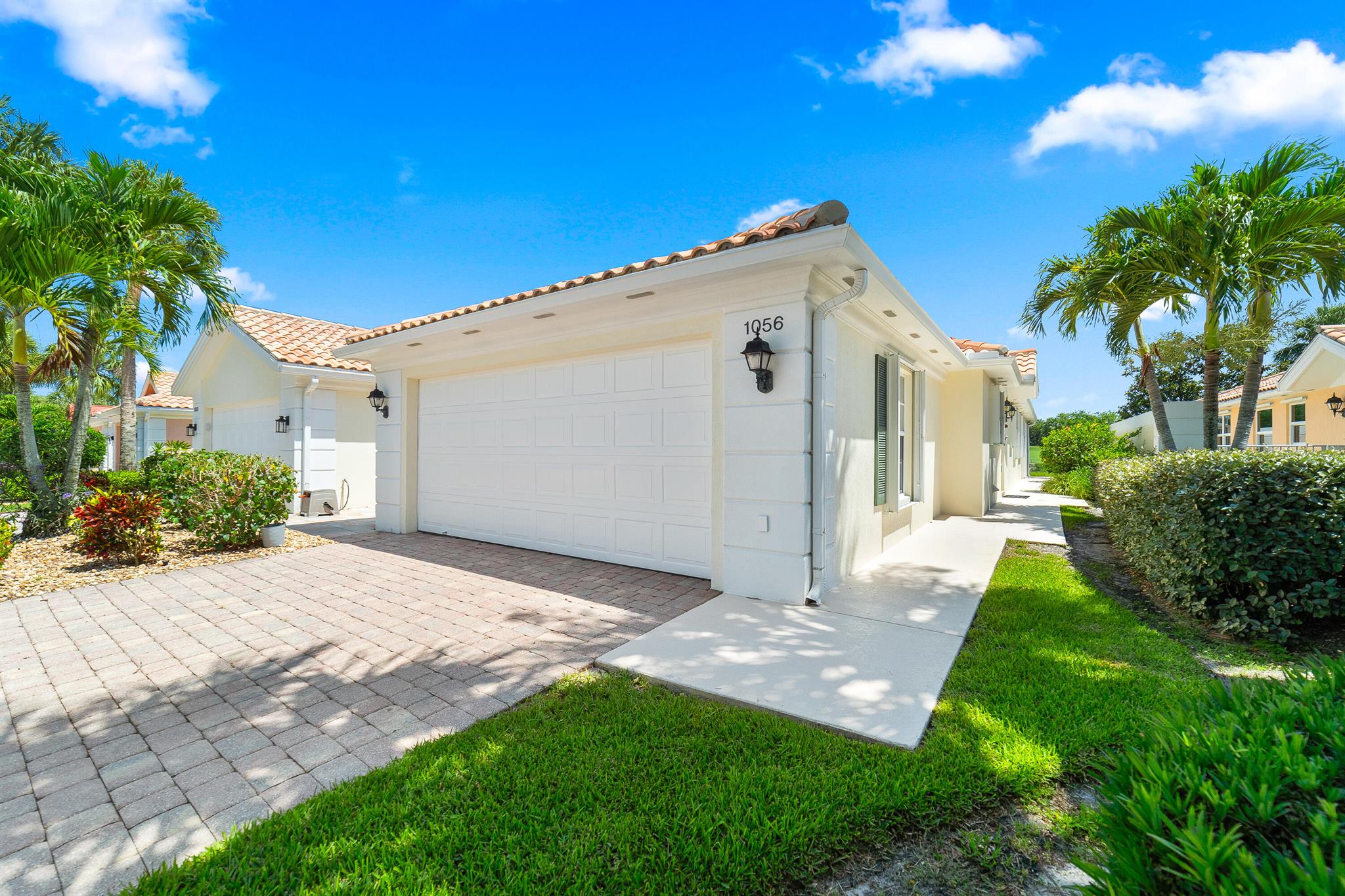 Welcome to this beautifully maintained villa in The Florida Club, featuring the sought-after Capri floorplan. Light-filled and inviting, the interior boasts a spacious layout with updated A/C and water heater, a central vacuum system, and a split-bedroom design for privacy. The kitchen offers abundant white cabinetry, granite countertops, and stainless steel appliances. The primary suite includes a walk-in closet, dual sinks, and a spa-like atmosphere. A generously sized guest bedroom sits at the front of the home with its own walk-in closet. Outside you'll enjoy the screened lanai with serene views of the 11th fairway and a tranquil lake--perfect for relaxing or entertaining. The attached 2-car garage adds convenience and storage. The Florida Club is an active, gated golf community in Stuart, FL, offering residents access to golf, tennis, a community pool, pickleball, and scenic oak-lined sidewalks ideal for leisurely strolls. Experience comfort, style, and the Florida lifestyle at its best. Home comes completely furnished. Low HOA fees.