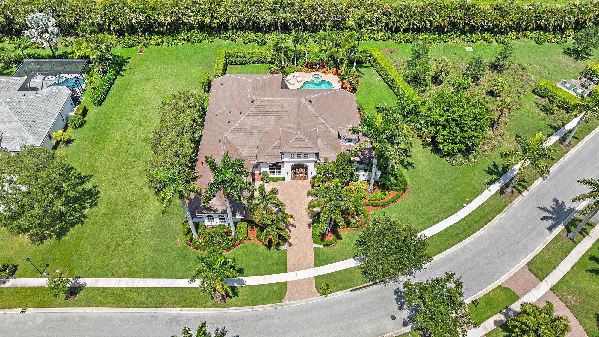 Sprawling Estate on One of the Largest Lots in Wildcat Run at The Club at Ibis. Designed for both luxury and functionality, this residence offers 4 bedrooms, 4.5 baths, a den, a billiard room, and a sitting room--an expansive and versatile floor plan ideal for elegant living and entertaining. Enjoy peace of mind with a NEW 2024 ROOF and IMPACT GLASS windows and doors throughout. The home seamlessly blends indoor and outdoor living with a spacious screened lanai (2017) that opens to lush landscaping and serene natural surroundings. Interior highlights include Jerusalem stone flooring, Brazilian Rosewood in the primary suite, extensive custom millwork, and coffered ceilings. Enjoy a spacious and true THREE-CAR GARAGE. Custom aluminum entry gates add to the curb appeal, while fresh paint&#x14;interior in 2023 and exterior in 2024&#x14;adds a move-in-ready polish. The expansive kitchen is a true chef's dream, thoughtfully designed with a spacious walk-in pantry and outfitted with top-tier appliances, including Bosch double ovens (2023), a Bosch microwave (2023), a Sub-Zero refrigerator (2006), a Bosch dishwasher (2006), and a professional-grade Thermador range. Elegant marble countertops complement the rich stone flooring, while custom wood cabinetry&#x14;featured throughout both the kitchen and Butler's Pantry&#x14;adds warmth, character, and timeless sophistication. Additional amenities include a wine cooler, built-in ice maker, and bar sink, perfect for entertaining. The home is equipped with Central Vac, an instant hot water dispenser, and a high-efficiency Samsung washer and dryer. Comfort and convenience are ensured year-round with three HVAC units&#x14;Lennox 2-ton (2018), Trane 4-ton (2016), and Lennox 3-ton (2018)&#x14;along with two Rheem hot water heaters: a 50-gallon (2018) and a 75-gallon (2019). Nestled within The Club at Ibis, an award-winning, private gated community, this residence offers access to a 90,000 sq. ft. clubhouse, three Jack Nicklaus family-designed championship golf courses, five exceptional dining venues, a state-of-the-art fitness center and spa, and a premier tennis and pickleball complex&#x14;delivering an unparalleled lifestyle experience.
