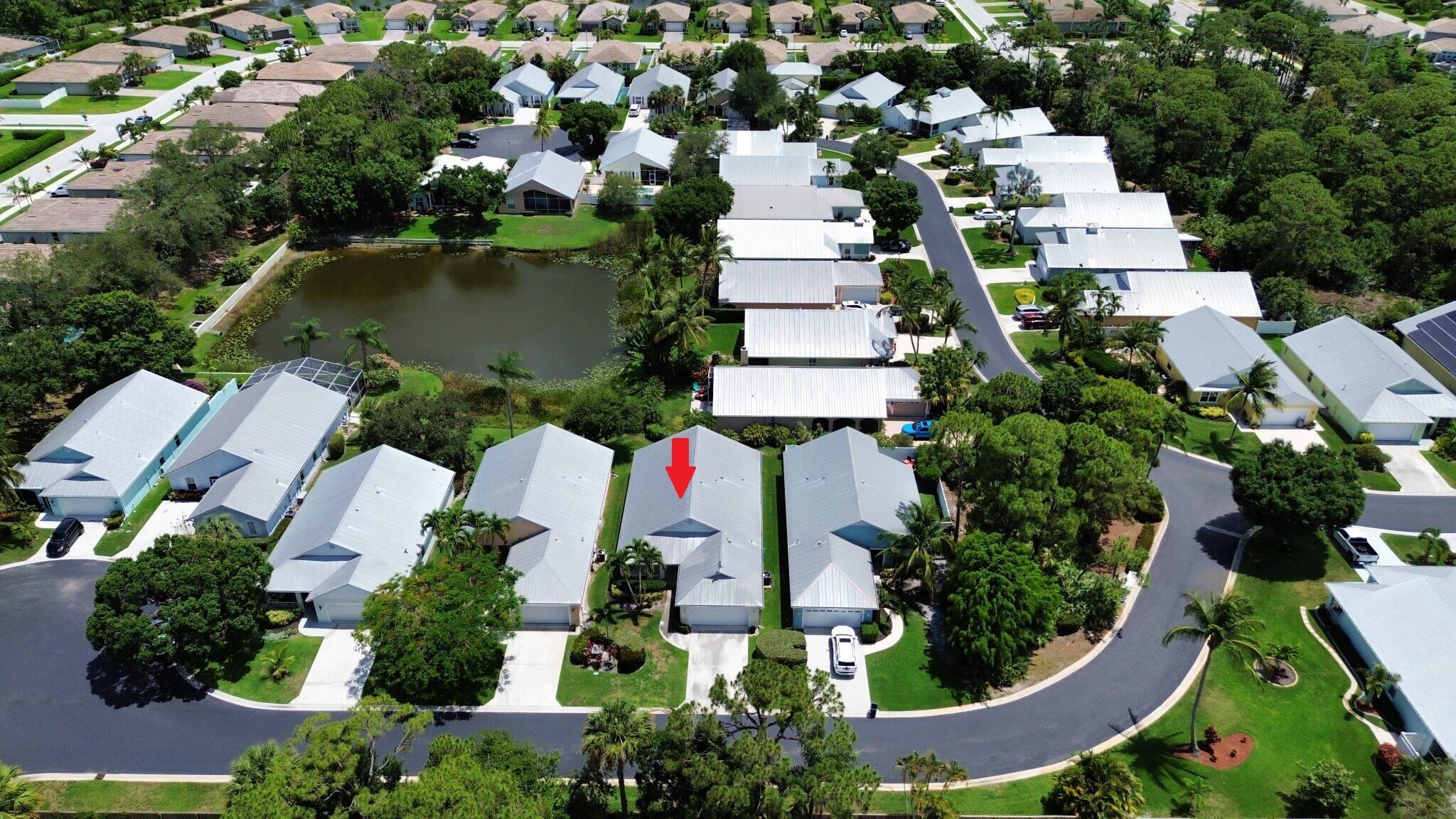 Waterfront 3 Bedroom plus Office, 2 Bath, 2 Car Garage CBS home in The Villas of Palm City. This spacious home features a New AC,  New Kitchen with Rich, Blue Shaker Cabinets, GE Profile SS Appliances including Gas Range, French Door Refrigerator, a Farm House Sink and Gold Hardware. The flooring has been replaced with a stylish Luxury Vinyl Plank in a neutral color. The primary and guest baths both have newer vanities and the Water Heater was recently replaced. A large Den/Office can easily be converted into a fourth bedroom. Enjoy views of the Lake and different waterfowl and wild life from your living room and covered patio. Storm Protection includes a metal roof, accordion and panel style shutters. The neighborhood is located just a short drive to local parks, St. Lucie River and