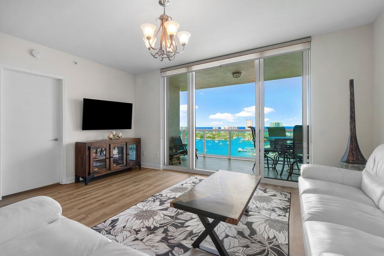 Updated 24th floor 2BR+den/2BA w amazing Intracoastal & ocean views, impact glass, semi-private elevator access. Open concept, split floor plan w LVT flooring throughout living areas & bedrooms. Stainless steel appliances in the open kitchen. Spacious owners suite w/his & her walk-in closets. Primary bath w/double vanity, jetted bath & water closet. Assigned garage parking & climate-controlled storage unit. 24/7 manned gate, valet. New covered rooftop oasis w/pool, spa, BBQ areas, tennis, pickleball. Clubhouse, fitness center & billiard room. Waterfront walking path w/gazebo. Adjacent marina w/dry docks available. Jump on your boat effortlessly & be on the ocean in minutes; no fixed bridges! Pet friendly.
