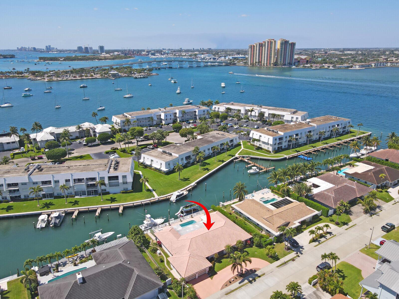 Waterfront Paradise on Singer Island! This unique 4-bed, 3 bath home offers direct Intracoastal access and is just minutes to the open ocean. Enjoy an open-concept layout filled with natural light, a custom kitchen with 6-burner gas stove, and spacious living areas perfect for entertaining. The primary suite features water views, a walk-in closet, and large en-suite bath.  3 additional bedrooms - one with en-suite bath, plus a den/office/5th room offer flexibility and privacy for family & guests. Outside, relax in your own private tropical oasis with a sparking pool, expansive patio, large boat dock and whole home generator for peace of mind. Located close to pristine beaches, dining, and shopping 1071 Singer Drive delivers the ultimate South Florida lifestyle!