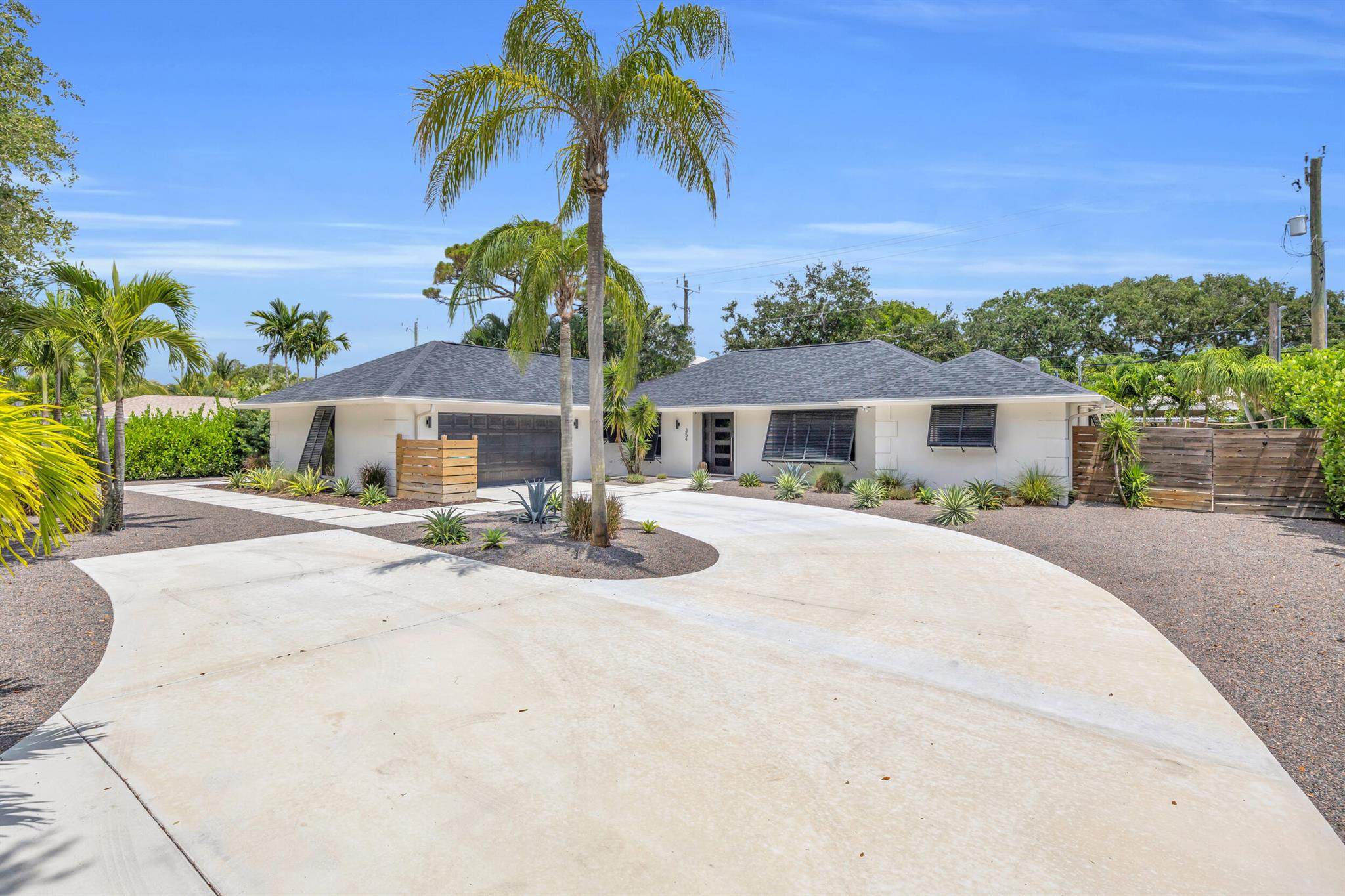 Welcome to Tequesta Country Club. This inviting and warm 4-bedroom pool home has been substantially updated in recent years. Notable updates include full hurricane impact windows and doors, roof (2020), air conditioning (2020), and new appliances. The focal point of this property is the newly updated, open kitchen. The large island, window out to the backyard and charming cabinetry make the kitchen space incredibly comfortable. Split floor plan promotes privacy and efficiency. Relax and entertain in your turn-key tropical backyard. Desirable features include synthetic turf, large tiki hut with built in table/bar, pool, privacy hedge, outdoor shower, paddleboard storage, and a full fence. Indoor bonuses are a laundry space, updated guest bath, wood flooring, and a buffet/bar area. Enjoy the convenience of attractive, low maintenance front landscaping and large driveway space. Plenty of room for your side yard boat storage. Tequesta CC offers residents a private boat ramp and day dock. This property is a golf cart ride away to Tequesta CC and Turtle Creek Club.