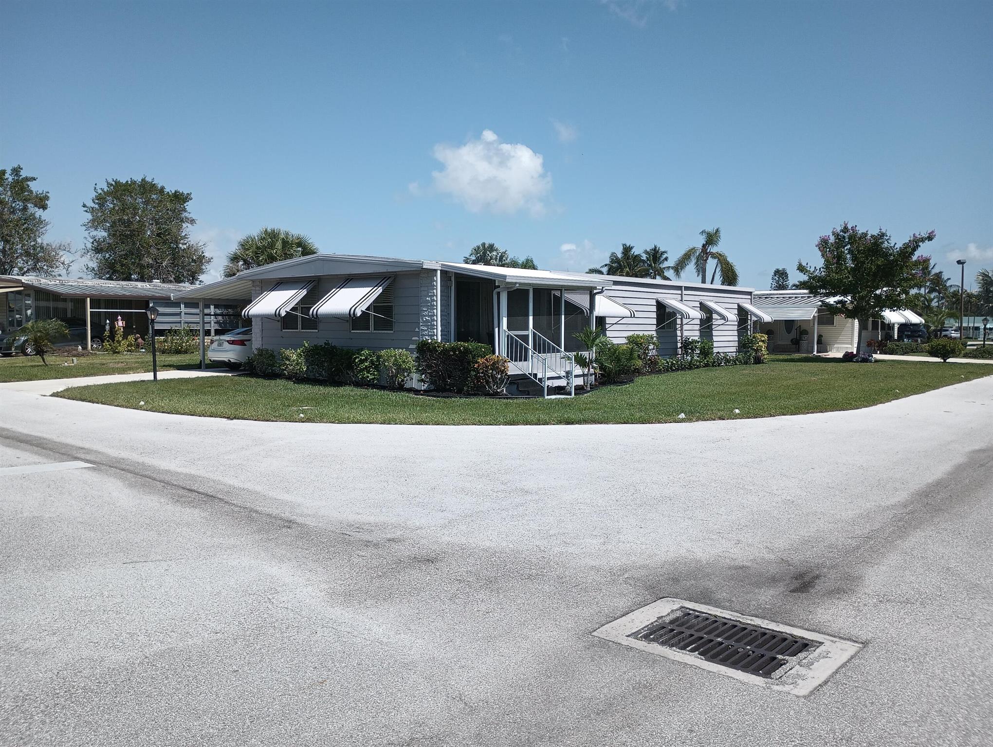 Large  double-wide manufactured home with plenty of rooms for guests and entertainment. New vapor barrier, Roof resealed Irrigation system upgraded. The interior has been painted, and a contactor has been hired to paint the exterior. New Landscaping, plus new hot water heater Home has been completely renovated Cooks and entertainers will love the open-concept kitchen with an island that faces the family room. Large sunroom off the living room with an additional enclosed screened porch. Recently remodeled ensuite and bathrooms. Lanai offers an additional sleeping area, and entertaining, with an entrance to the laundry, and workroom.The community location is Pinelake Village which offers a pool, hot tub, fitness center, clubhouse, additional amenities,HOA $765 per month