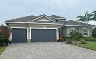 Stunning newer home in gated private waterfront community of Langford Landing. Popular St. Croix model features spacious open-concept layout all on one level w/ soaring 12' ceilings. Grand entrance foyer leads into the main living area, gourmet kitchen, and breakfast area. Home has a lg primary BR and luxury bath, his/hers w/inclosets, 2 additional en-suite guest BRs, a large formal DR, private den or possible 4thBR, tech rm, powder B, butlers &  food pantry plus storage room. 3 car climate controlled garage features 80amp. 240 V EV charging station plus 50amp.outlet for 2nd charger. Home has blown in insulation in the attic & smart home technology. The solar panels on the roof (owned, not leased) provide electricity to the home with and can fully power the home in an emergency. Zone X Large covered and screened lanai offers a summer kitchen with gas range, sink, icemaker, and beverage refrigerator. Large heated saltwater pool, Tiki hut and lushly landscaped yard and stunning sunsets complete this backyard oasis. Take your golf cart down to the community marina where your 40' boat slip with 24k lift awaits you for your boating fun on the St Lucie River. Minutes by boat to downtown Stuart, Port Salerno or head to the Stuart Inlet for direct ocean access with no fixed bridges. This is Florida Living at it's best!