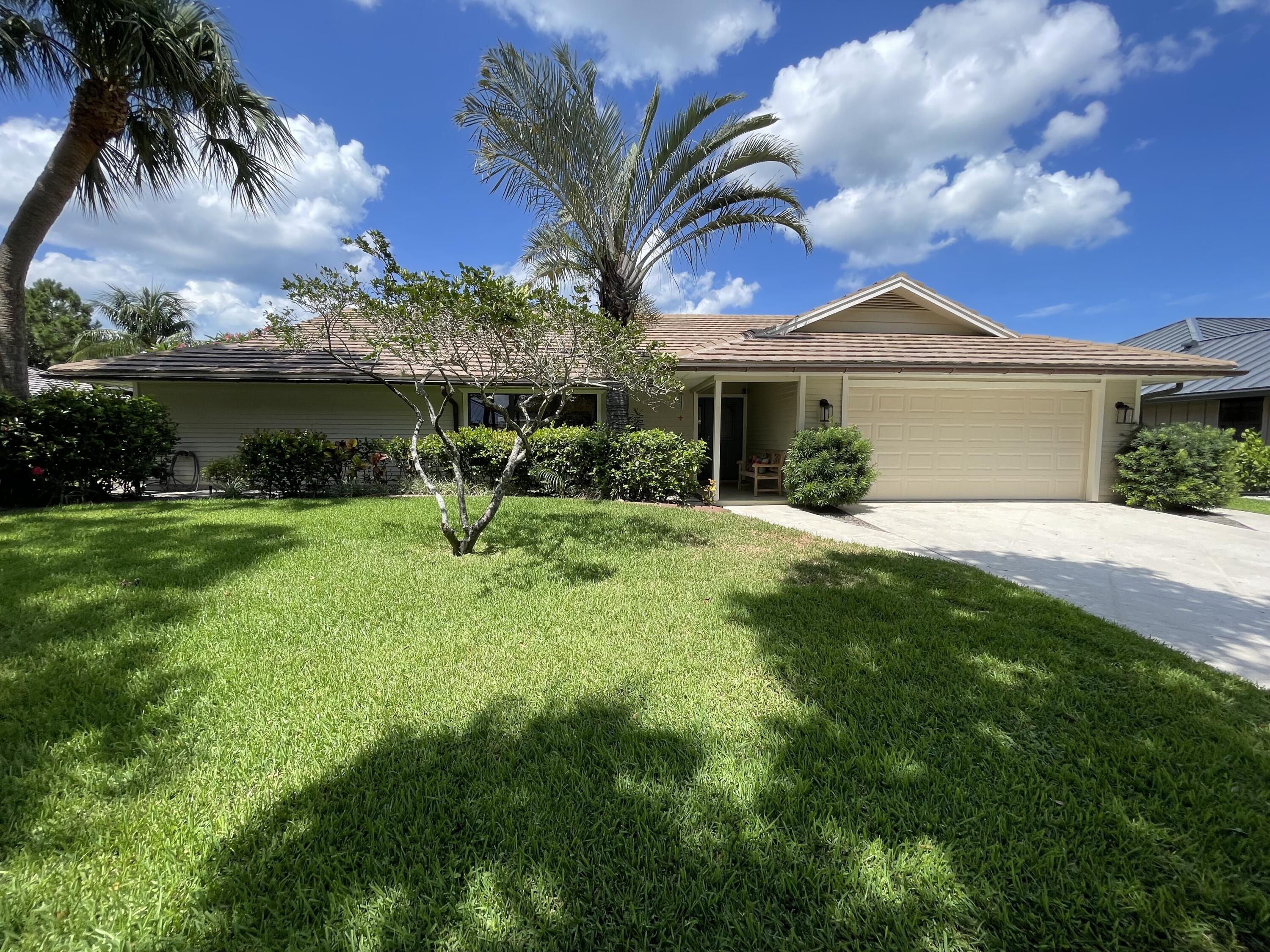 This captivating single-story home nestled within the coveted community of The Shores offers serene lake and tree-lined views. Located on a premium lakefront lot, the open concept split bedroom floor plan features 3 bedrooms, 2 1/2 baths, a 2 car garage and a private pool. Soaring vaulted ceilings and large windows welcome you into the living room which is the perfect conversation area to entertain guests. Beautiful wide-plank luxury vinyl flooring runs throughout the living areas and primary suite. Gather in the family room for movie night next to the cozy coquina limestone fireplace. Whip up your favorite dishes from the upgraded kitchen featuring solid wood cabinetry, granite countertops, a tile backsplash, bar seating and a pass through window to the pool area. The inviting formal dining room offers lovely pool &amp; tropical views and is adjacent to the kitchen &amp; living room, allowing you to entertain effortlessly. Rest peacefully in the expansive primary suite boasting a large walk-in closet, a stylish light fixture, bamboo shades &amp; sliding glass door access to the pool area. Pamper yourself in the relaxing primary bath featuring dual vanities, a walk-in shower with dual showerheads &amp; toiletry niche, porcelain shower tile, and marble flooring. Both guest bedrooms are comfortable and abundantly sized with large walk-in closets. A convenient powder room is located near the family room and the full guest bath doubles as a cabana bath with access to the pool area. The backyard oasis features an enormous covered patio, a turquoise private pool, a full screen enclosure and peaceful lake and garden views. The Shores of Jupiter has low HOA fees and is conveniently located in an A-rated school district and within close proximity of I-95, the FL Turnpike, pristine beaches, shopping, restaurants, parks &amp; nature preserves. With a total of 136 acres of lakes and preserves, the community offers residents a serene and tranquil living experience. The entrance to The Shores of Jupiter is marked by a scenic drive lined with sidewalks, grassy areas, trees, and lakes. There are two parks in the neighborhood for residents to enjoy. The Tot Lot "Kuretski Park" offers playground equipment, benches &amp; a "little free library" and is located at the corner of Longshore Drive and Misty Lake Drive. The Slough Park "Zisson Park" located on the corner of Longshore Drive and Winding Lake Drive has benches and open space for you to enjoy the gorgeous Florida weather. Live your best life here!