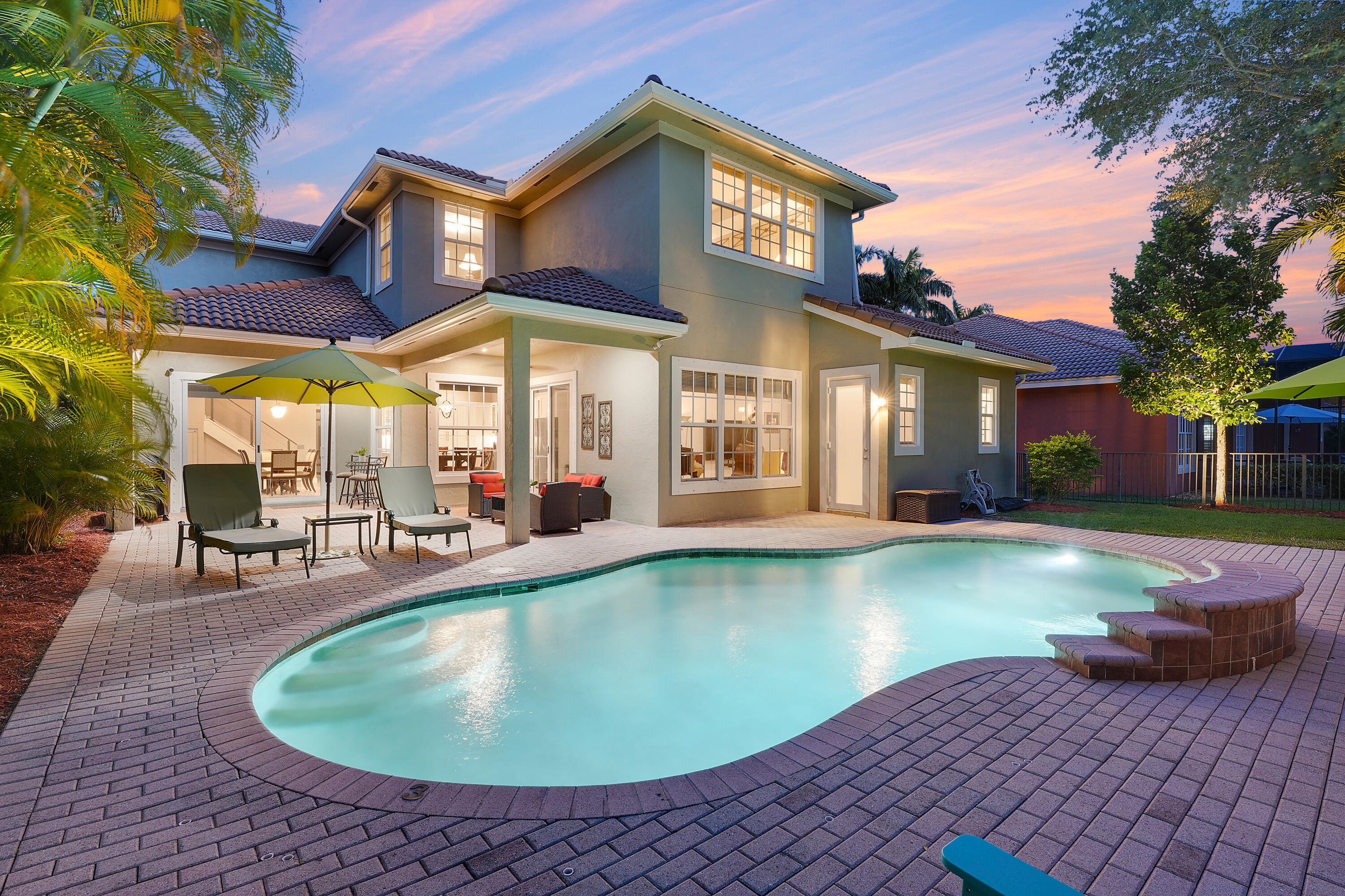 Tucked away in the heart of Jupiter, this extraordinary lakefront retreat offers approx. 3200 sq ft of unmatched privacy, with no neighbors behind you--just tranquil water views and lush landscapes. Set on a premium lot, the home has undergone a complete transformation, blending luxury with thoughtful design at every turn. Step inside to discover full hurricane-impact windows and doors, ensuring peace of mind and a serene living environment. The reimagined floorplan introduces a private office--an exclusive addition not found in similar models. The kitchen is a beautiful blend of design and craftsmanship, featuring high-end cabinetry, stunning countertops, and top-tier appliances, including a new refrigerator, drawer microwave, electric range, oven with a built-in air fryer, and dishwasher Copper accents, including a striking hood, complement elegant island pendants, creating a warm and sophisticated ambiance. With four bedrooms, four bathrooms, and a dedicated office, this home embodies both comfort and functionality. Brand-new water-resistant vinyl wood flooring flows seamlessly throughout, leading to a modern stairwell and beautifully renovated bathrooms. Two high-efficiency A/C units and freshly cleaned, recoated air ducts guarantee a pristine, energy-efficient environment. On the first floor, a guest bedroom with its own full bath offers an ensuite-like retreat, while an additional cabana bathroom provides direct access to the pool, perfect for seamless indoor-outdoor living. The newly designed office/den, adorned with custom cabinetry and elegant doors, creates an inspiring workspace with added privacy.

This home also caters to a multigenerational family with the private bedroom, full bath and den/office on the first floor.
 
Step outside to an oversized, fully fenced backyard, lush with landscaping and designed for relaxation. Take a dip in the saltwater pool, now equipped with a new chlorinator and pool pump the ultimate way to embrace Florida living.
Throughout the home, designer touches abound, from beautiful light fixtures with dimmers in every room to custom window treatments, updated baseboards, door frames, and brand-new interior doors.

This exterior elevation also offers upgraded porte-cochere' and the covered porch in the front of the home, offering covered parking and a nice way to stay dry on rainy days! 
 
Beyond the home itself, Jupiter offers an unrivaled lifestyle, with access to world-class golf, boating, fishing, and crystal-clear waterways. Enjoy top-rated schools, sports for all ages, vibrant local community events, outdoor concerts in Abacoa, baseball games at Roger Dean Stadium, bustling farmers markets, and incredible shopping. Conveniently located just 25 minutes north of downtown West Palm and Palm Beach Island, 1.5 hours north of Miami, and 2 hours south of Orlando, this home places you at the center of it all. Even Palm Beach International Airport, widely regarded as one of the easiest airports to navigate, is just a 25-minute drive away.
 
Make sure to watch the property video! With approximately 3,200 sq ft of beautifully curated living space, stunning outdoor areas, a premium lakefront lot, and an exceptional floorplan, this home is an exquisite blend of comfort, style, and modern convenience an absolute gem in the Paseos community.