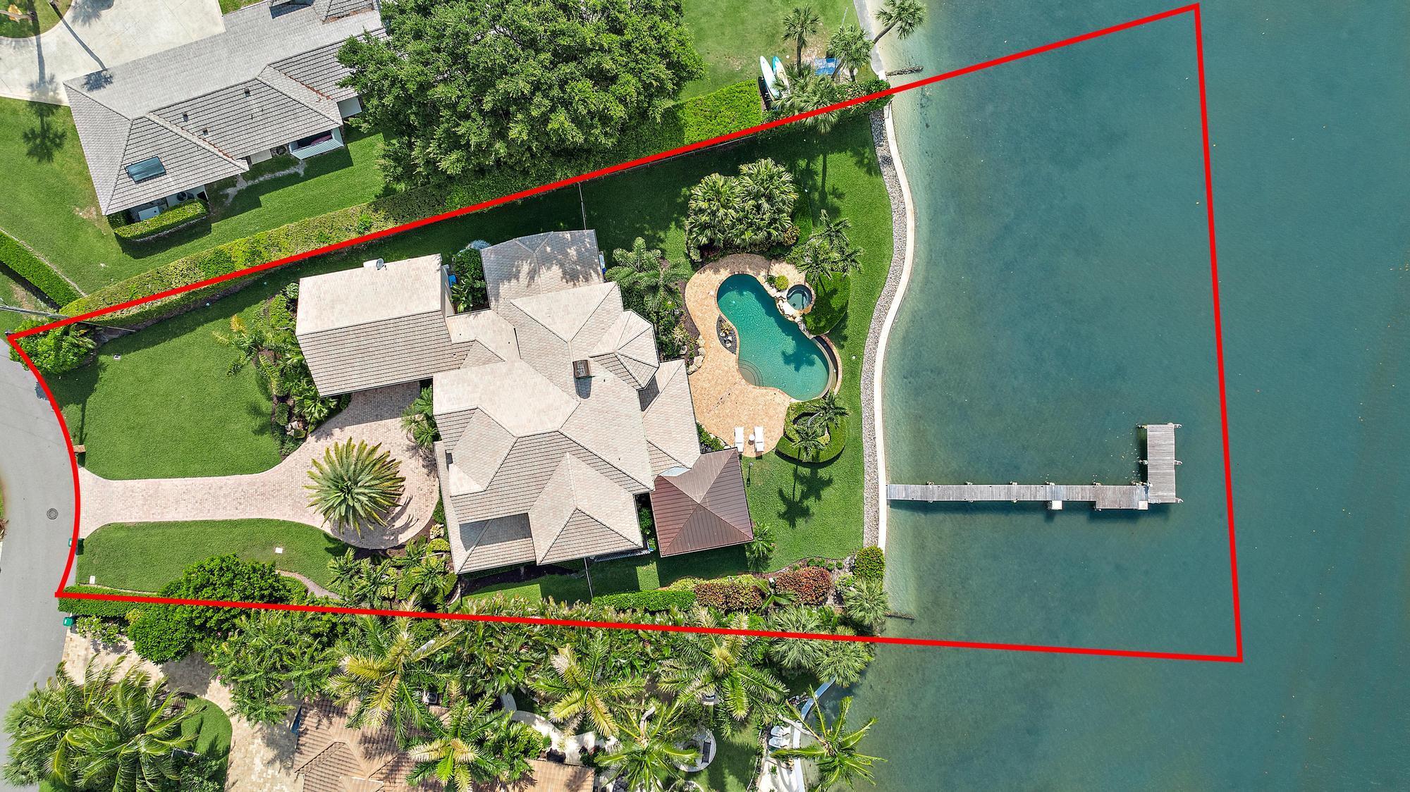 Located in Tequesta Country Club, on an oversized lot, this stunning two-story waterfront home sits on nearly half an acre with over 130' of wide waterfrontage. The southern exposure offers breathtaking views with incredible sunrises and sunsets. With 4,845 sqft under air, the home features 5 bedrooms, 3.5 bathrooms, a large versatile bonus room, a house generator, a heated infiniti pool and spa, a tranquil outdoor covered sitting patio, lots of storage and a 2-car garage with bonus workshop. Recent upgrades include, but not limited to, 3 AC units, 2 hot water heaters, new pool equipment, newly constructed outdoor sitting patio with retractable hurricane rated screens and a beautifully redone dock with Brazilian wood. Don't miss this one-of-a-kind opportunity!