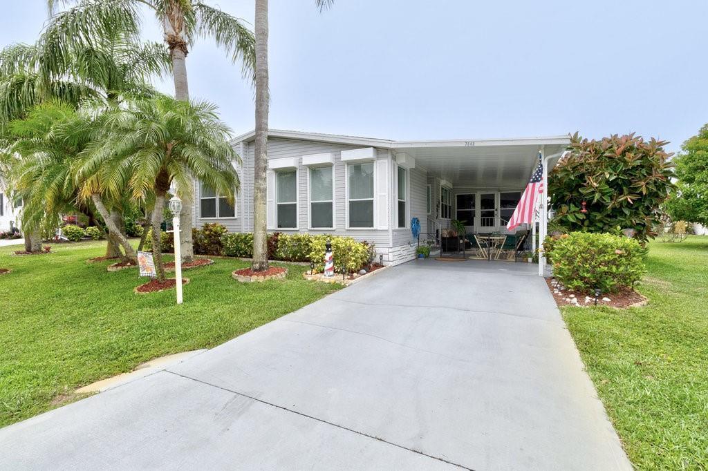 Honey, THIS IS IT! This is the Dream Home you have been searching for. EXTRA LARGE LOT (72X100)and NO LOT RENT! MOVE IN READY, conveniently located across from the CLUBHOUSE. AMAZING Kitchen clean & bright, expansive countertops, storage galore + a Coffee Bar too. Master Suite, Huge Closet. Master Bath: DOUBLE sinks & Walk-in Shower. Hurricane Ready with ROLL DOWN shutters+panels. INSIDE Laundry w/W&D included. SHED/WORKSHOP w/Utility Sink. AIR CONDITIONED Raised Enclosed Patio. AC 2022, Plumbing Updated 2023, 2024 Interior Painted. Almost 2000sf under air with enclosed Patio. MUST SEE.
