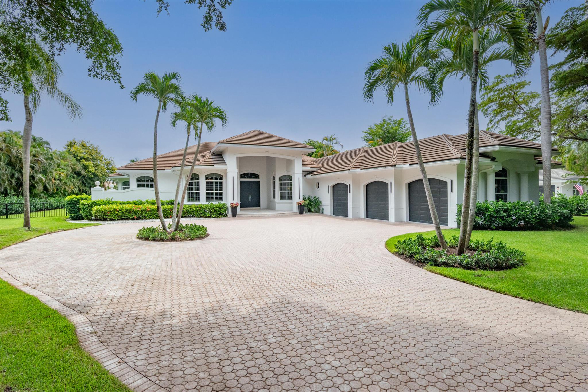Stunning renovated one-story home in Palm Beach Gardens on an acre+ lot in the gated community of Steeplechase. Perfectly placed on a large homesite with exceptional finishes, a large custom heated pool and inviting outdoor areas to relax. The beautifully updated kitchen features high end appliances coupled with new quartz countertops and top-quality cabinetry. The luxurious primary suite has a re-designed bathroom, huge closets with custom built-ins and great views of the pool/spa and newly landscaped backyard that is fenced and very private. With over 6,200 square feet of living space on one level this spacious floorplan offers five guest bedroom suites, office, media room and game room with built-in bar. The family room is highlighted by a coquina fireplace & a great view of the pool.