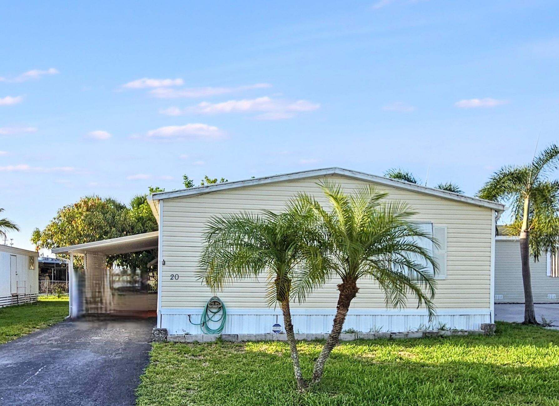 Own the land and the home in this desirable gated community!  This fully furnished 3-bedroom, 2-bath mobile home offers comfortable living in a community where you own both the land and the home--no lot rent! Featuring quality furnishings and a desirable split-bedroom layout, this home is move-in ready. Recent upgrades include a new Payne A/C unit (2024), Bath Fitter tub/shower (2022), water heater (2020), and propane system (2025) for gas stove. All appliances and washer/dryer are included.

A metal roof with rubber coating and panels for windows provide additional security, protection, and peace of mind.

Enjoy relaxing in the shaded yard under the fruit trees, parking under the covered carport, and the convenience of an extra parking space, perfect for guests, a boat, or an additional vehicle.

Ideally located just minutes from the Intracoastal, stunning beaches, downtown West Palm Beach, top shopping destinations, and the Ballpark of the Palm Beaches, this home also offers quick access to I-95, the Florida Turnpike, and Palm Beach International Airport.

The low monthly HOA fee of just $63 includes access to community amenities such as a clubhouse and pool. Walk to nearby shopping and restaurants.  Perfect as a seasonal getaway or year-round residence.

This is a rare opportunity to own a move-in-ready home in West Palm Beach, one of the hottest and fastest-growing neighborhoods in South Florida.