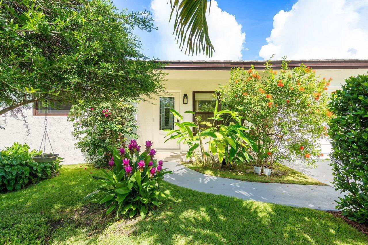 Surrounded by million-dollar estates and exciting new development, this 3BR/2BA East Lake Worth home is a tranquil retreat in the heart of it all. Completely remodeled with care, every detail was chosen with intention--from the open layout and custom kitchen and closets to the lush landscaping, imported grass, and hand-selected plants that create a sense of grounding and peace. Impact windows and a finished garage offer comfort and security, while expansive garden views bring natural light and serenity into every room. Ideally located just minutes to the beach, downtown West Palm, and Lake Worth's historic charm, this is a rare opportunity for those seeking beauty, presence, and possibility. Priced to find the next homeowner quick, so Call Today!