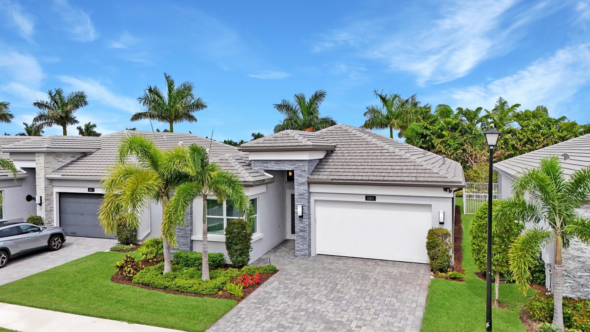 Welcome to this beautifully appointed 2-bedroom plus den, 2-bath home in the sought-after community of Valencia Sound. From the moment you arrive, you'll appreciate the covered entry and elegant impact glass front door, complemented by full impact windows throughout. Inside, engineered wood flooring, high hat lighting, and an open-concept floorplan create a bright and inviting atmosphere.  The stylish kitchen is designed to impress with sleek grey cabinets, Quartz countertops, a center island with a dramatic waterfall edge, under- and above-cabinet lighting, pendant lights, a 5-burner gas stove, stainless steel appliances, a snack bar, and a charming breakfast nook. The den offers flexibility as a home office or guest space. The primary suite is a serene retreat featuring dual closets, double sinks, abundant cabinet space with convenient pull-out storage, and a spacious walk-in shower.
Additional highlights include a central vacuum system, a well-appointed laundry room with storage cabinets, and an epoxy-coated garage floor. Relax on the screen-enclosed patio while enjoying peaceful lake views perfect for entertaining or quiet mornings.

Don't miss the opportunity to enjoy luxury living in one of Valencia Sound's finest homes.
Valencia Sound is a premier 55+ community offering an exceptional resort-style lifestyle in a vibrant and luxurious setting. At the heart of the community is a spectacular clubhouse featuring a grand ballroom, social hall, and a full-service catering kitchen perfect for hosting events and gatherings. Residents can stay active and engaged with a state-of-the-art fitness center, locker rooms, steam rooms, and massage rooms, as well as a dedicated arts and crafts center and multiple card rooms for socializing and creative pursuits.

Outdoors, the community offers a stunning resort-style pool, lap pool, relaxing spa, and a wading pool for visiting grandchildren. Sports enthusiasts will enjoy the professional-quality tennis courts, pickleball courts, and bocce ball courts. With its full calendar of events, upscale amenities, and vibrant atmosphere, Valencia Sound delivers the ultimate in active adult living.