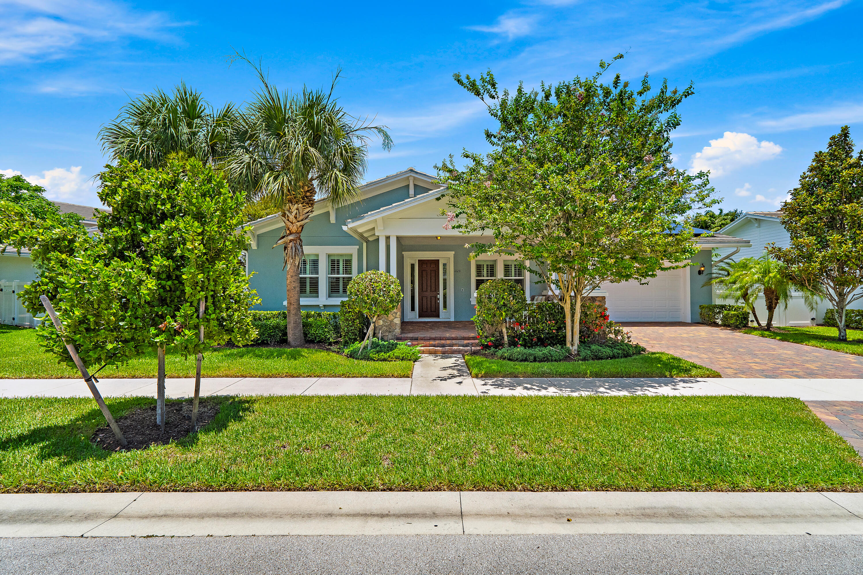 This delightful CBS Divosta home was built in 2016 and offers the perfect blend of comfort and modern efficiency.  A must-see property w/ Impact Glass, a 13 kW photovoltaic solar array (Hanwha Q-Cells) and two 5 kW Tesla Powerwall batteries make 1123 Sweet Hill energy-independent w/ continuous, uninterrupted power even during an outage. The system also reduces energy costs significantly and is covered by a transferable warranty.  LEARN MORE ABOUT HOW SOLAR CAN WORK FOR YOU.  Step onto the inviting front porch nestled between Hibiscus + Palms, and you will find a terrific place to unwind and greet friends too! Inside, this home features a spacious single-level layout w/4 bedrooms, 3 full baths and sizeable living spaces. Stylish wood plank porcelain tile floors, The kitchen, complete w/ white cabinets, a center island, pantry and stainless-steel appliances, seamlessly connects to the family room and dining area.  Relax in a primary suite w/private patio, and bath w/soaking tub, large dual vanity + two spacious walk-in closets. With one ensuite bedroom and a Jack &amp; Jill bath serving two others, there's plenty of room for family and guests.  The expansive fully fenced and treed backyard offers an ideal setting for play areas, BBQs and a custom pool; although the Windsor Park Clubhouse pool is close by. Calling garage enthusiasts! Clean as a whistle w/a high-performance epoxy floor and like new composite wood storage system including workbench. Fantastic neighborhood with so much to offer~ pool, clubhouse, fitness center, playground, and being within Abacoa you will find Abacoa Golf Club, the Dog Park, Ball fields, Soccer fields, Restaurants, Shops and more.  Currently zoned Lighthouse Elementary, Beacon Cove, Independence Middle, and Jupiter High.