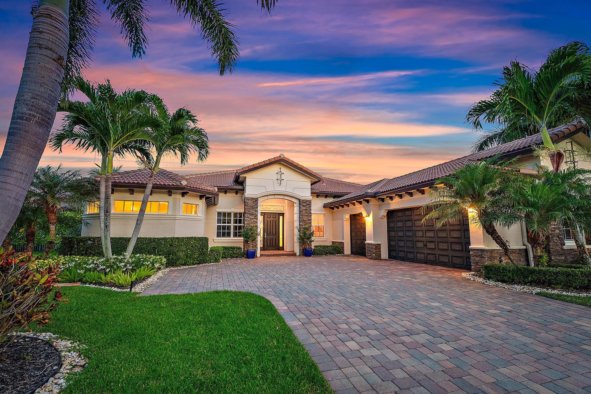 Nestled in the prestigious gated community of Rialto, this elegant Stockton model lakefront home offers the perfect balance of luxury, comfort, and refined Florida living. Spanning just over 3,000 square feet of air-conditioned space, this thoughtfully designed single-story residence features four spacious bedrooms, a versatile office or den, and three full bathrooms, making it ideal for both relaxed everyday living and elegant entertaining.As you step through the front door, you're welcomed into a bright and airy interior defined by soaring ceilings and an open-concept floor plan. Rich wood flooring flows throughout the main living areas and into the primary suite, creating a warm, cohesive aesthetic. The home's layout follows a desirable split-bedroom plan, affording the primary and guest suites enhanced privacy and tranquility. Crown molding, custom window treatments, and a unique revolving door that leads into the den or office space elevate the home's design and overall charm.

The primary suite serves as a luxurious personal retreat, with sliding glass doors that open directly onto a private lanai. From here, you can step into the heated, saltwater pool and spa, enjoying views of the beautifully landscaped backyard and serene lake beyond. Inside the suite, a spa-inspired bathroom awaits, featuring a massive walk-in shower, a soaking tub, dual sinks set in elegant quartz countertops, and generous his-and-her closets with custom built-ins that provide both function and style.

The kitchen is a chef's dream, boasting modern white shaker cabinets, expansive quartz countertops, and top-of-the-line stainless steel appliances, including a double wall oven and wine cooler. A snack bar offers additional seating and a perfect casual dining spot. Ample storage is provided with abundant cabinetry and a spacious walk-in pantry. Adjacent to the kitchen, the breakfast area and family room open effortlessly onto the covered lanai, creating a seamless flow between indoor and outdoor living spaces that is perfect for entertaining or simply enjoying the peaceful lakeside setting.

The backyard is truly a private oasis. The large, covered lanai offers shaded lounging space, while the heated, saltwater pool and jacuzzi provide year-round enjoyment. Beyond the pool, the fenced yard is adorned with lush landscaping and mature greenery, ensuring privacy and tranquility.

Additional features that set this home apart include energy-efficient solar panels that significantly reduce utility costs, an air-conditioned garage with built-in storage racks, and a prime location tucked away from the highway for added peace and quiet. This meticulously maintained residence is the ideal combination of high-end finishes, smart design, and resort-style living in one of Rialto's most desirable locations.

The community of Rialto is renowned for its luxury amenities, including a clubhouse with a state-of-the-art fitness center, a kids' splash park, a resort-style pool and jacuzzi, multiple playgrounds, basketball courts, two tennis courts, and scenic walking and jogging trails. The active social committee ensures a vibrant community atmosphere with events for all ages. Located within an A-rated school district and across from a scenic nature preserve, Rialto is just minutes from Jupiter's pristine beaches, upscale restaurants, and premier shopping. With convenient access to I-95 and the Florida Turnpike, Palm Beach International Airport is only a short drive away, making this home the perfect blend of luxury, convenience, and community living.