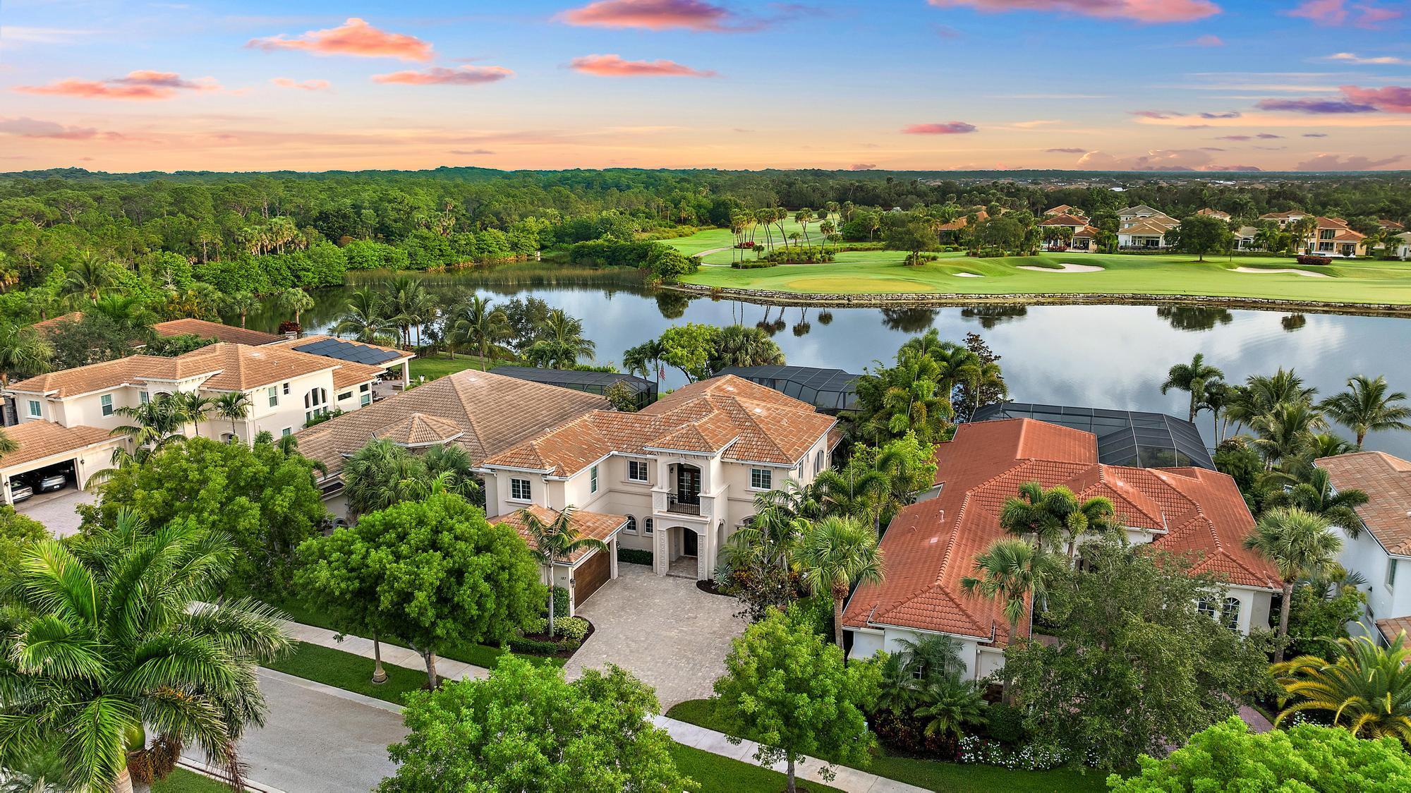 IMMEDIATE ACCESS to a FULL GOLF MEMBERSHIP! Wake up to golden sunrises over still water and lush fairways at 187 Carmela Ct. -- a private estate in Jupiter Country Club where luxury meets lifestyle. Set on one of the most coveted lots in the community, this move-in-ready home offers sweeping water and golf course views, and a freshly painted interior. Designed for both growing families and seasonal residents, the flexible floorplan features a main-level primary suite and guest suite, plus two additional guest suites upstairs. Entertain with ease in the beautiful kitchen, unwind in the screened lanai, or take the golf cart for dinner at the club. With a 2-car garage plus dedicated golf cart garage, this home blends elegance with everyday convenience. All within a gated community offering tennis, pickleball, state-of-the-art fitness, dining, and a Greg Norman-designed golf course &#x14; just minutes from beaches, boating, top dining, and neighboring Riverbend Park.  Various photos are virtually staged with furnishings.
