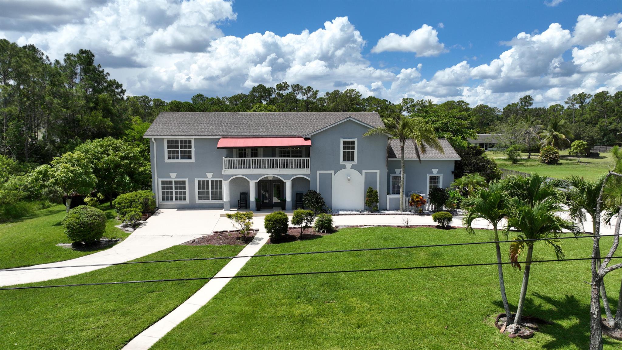 UNDERPRICED TO SELL QUICKLY! This beautiful and spacious, move-in ready CBS home is perfect for MULTI-GENERATIONAL living. It features TWO PRIMARY SUITES and laundry rooms with new washer and dryer on BOTH floors. Situated on 1.29 fenced acres in a NO-HOA community with A-RATED SCHOOLS, this home offers expansive soaring 20' ceiling in the foyer, volume, two-step tray ceilings, LED lights, elegant crown moldings, French doors and three modern fireplaces for great ambiance. There are TWO PRIMARY suites, one on each floor. The FIRST LEVEL features a gourmet kitchen, an oversized PRIMARY suite with a huge custom 12'x12' closet (converted from a full bedroom to a closet), plus 2 full bathrooms. The SECOND LEVEL offers a full kitchen, 3 bedrooms and 2 bathrooms. The MAIN gourmet kitchen, remodeled in 2023, boasts gorgeous quartz countertops, stainless steel appliances, backsplash, a convenient island, and a cozy breakfast nook. The 2nd floor kitchen is equipped with new appliances. Unwind in the primary suite's infrared sauna or host unforgettable gatherings in the amazing outdoor kitchen and lush backyard, complete with mango, avocado, and soursop trees. A deck, turf area, and room for a pool make the space even more inviting. There is a NEW 5-tonn HVAC (2024). The home is conveniently located to Westlake's shopping and dining. All measurements are approximate. Explore the 3D virtual walkthrough.