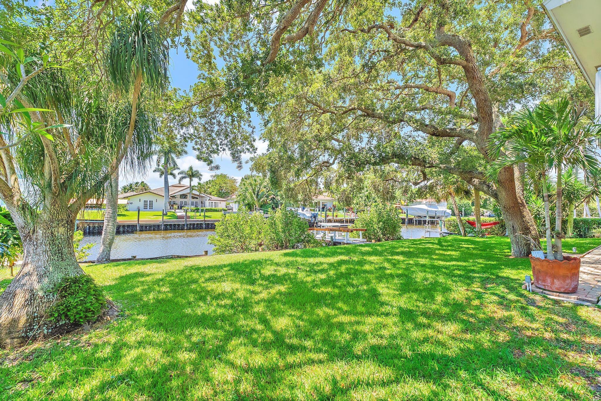Nestled in Palm Beach Gardens, this Key West-style residence is a serene waterfront retreat set on one of the largest deepwater lots in the area, spanning a rare and expansive .43 acres. Towering mature Oaks and voluminous ceilings create an airy, coastal elegance, while the private dock with 16,000lb lift offers direct access to South Florida's prized waterways. The chef's kitchen showcases rich Heartland wood cabinetry, GE Profile appliances, and granite countertops. Recent upgrades include fully renovated bathrooms, an enhanced dock, and a state-of-the-art water filtration system that elevates everyday living. Tucked away on a quiet, exclusive street, the home also features a spacious recreation room and an oversized garage with workshop ....