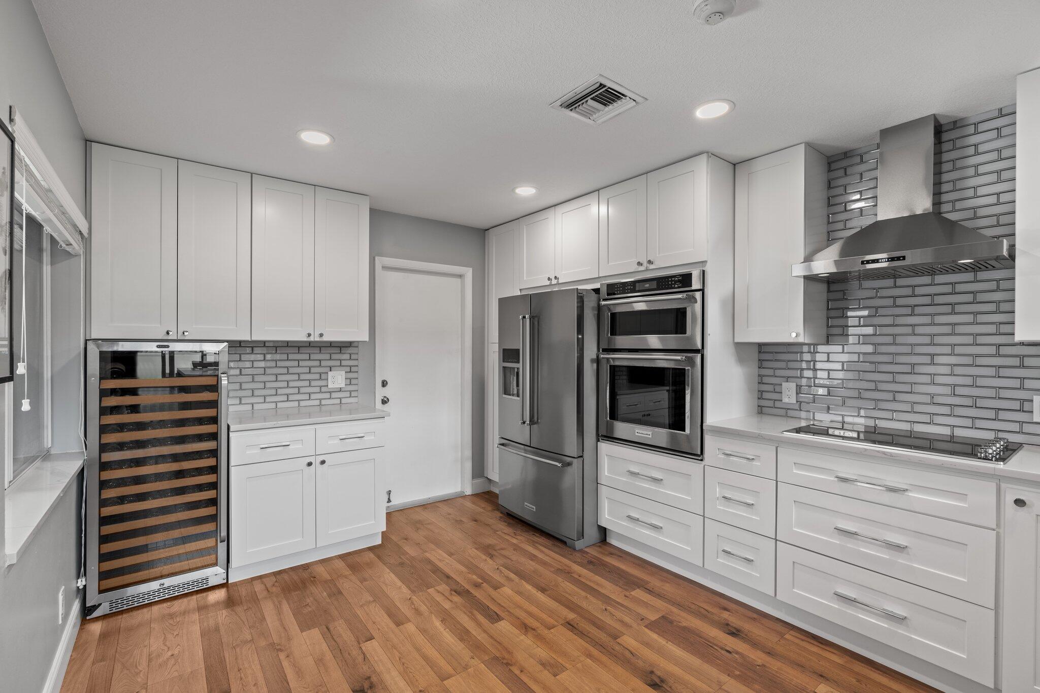 Welcome to this stunning 3-bedroom, 2.5-bathroom townhouse featuring soaring 18-foot ceilings and an open, airy layout filled with natural light. The home boasts laminate flooring throughout and an updated kitchen with custom shaker cabinets, quartz countertops, a wine bar, and brand-new appliances--perfect for entertaining and everyday living.The spacious primary suite offers a luxurious retreat with a fully renovated bathroom that includes a freestanding soaking tub, a large walk-in shower, and generous walk-in closets. Additional bedrooms also feature ample closet space.Enjoy added peace of mind with accordion shutters on all windows and doors. The attached garage includes custom flooring and built-in storage, combining function and style. Other highlights include a 2021 roof and access to resort-style community amenities such as a private pool and jacuzzi. Located within an A+ rated school district, this beautifully maintained home offers the perfect blend of comfort, security, and convenience in one of West Boca Raton's most desirable neighborhoods.