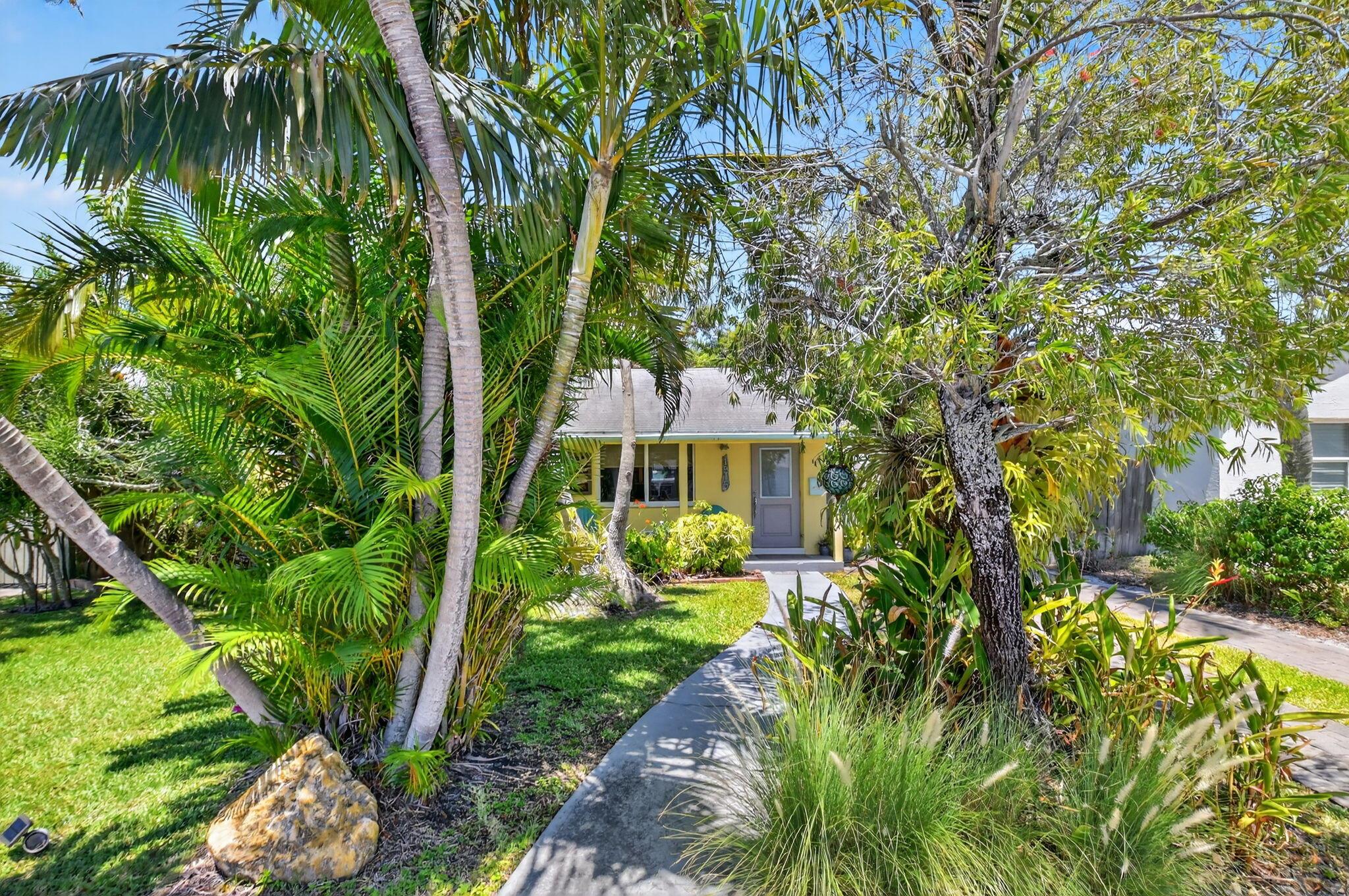 Adorable Key West style cottage home in desirable northeast end of Lake Worth Beach! This charming, concrete, beach-inspired home is one not to be missed. The main house is bright and open with lots of hurricane impact glass windows. Updated kitchen has 2 breakfast bars, stainless steel, granite, a farmhouse sink, and wine/drink chiller. Primary bedroom has a roll-in shower floor and large walk-in closet. Beautiful Terrazzo and tile floors. The detached building behind the house, has power, water, is partially air-conditioned and has a huge amount of storage space and the washer/dryer. The private, fenced backyard even has an outdoor shower! Convenient location near wonderful restaurants, Lake Worth Golf Club, shops, entertainment and Lake Worth Beach. Furniture is negotiable.
