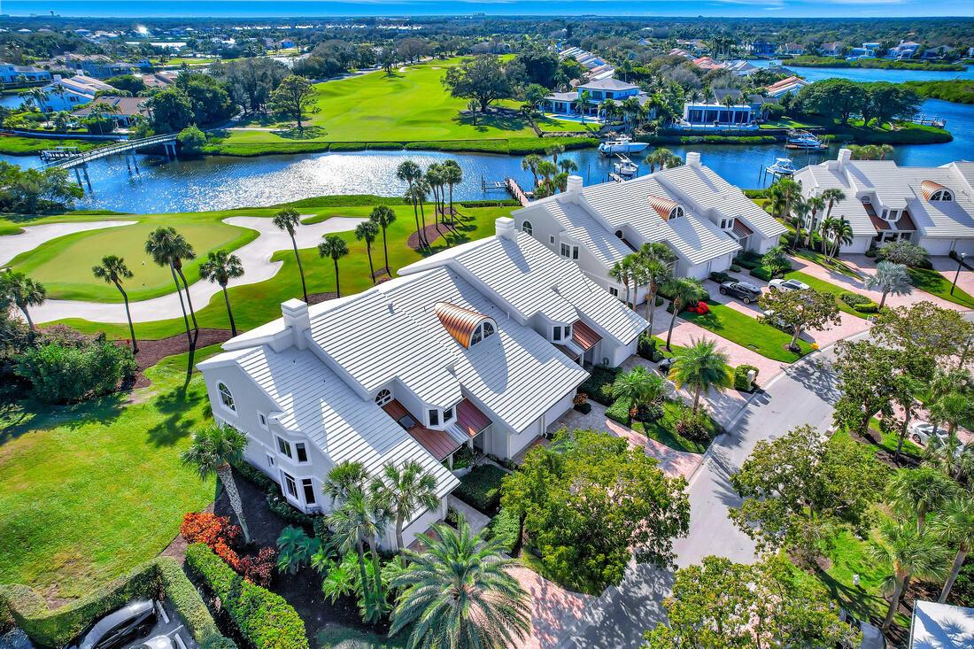 Perched above the 18th fairway and green, this beautifully renovated 3-bedroom, 2.5-bath Harbor Home offers stunning southern exposure and captivating, forever views. The open-concept contemporary kitchen shines with quartz countertops, decorative tile backsplash, and brand-new KitchenAid appliances--including induction cooktop, wall ovens, and a breakfast bar--combining style and functionality. The luxurious primary bath features an oversized shower and dual sinks. Additional highlights include a private elevator, wine cooler at the bar, and a private dock with lift, accommodating boats up to 34 feet. Just steps from the Admirals Cove clubhouse, this home offers unrivaled access to world-class amenities and an easy, luxurious coastal lifestyle. Required golf membership purchase conveys all the first class amenities of Admirals Cove including two spectacular clubhouses, 45 holes of golf, 5 restaurants, 58 slip marina with floating docks, Yacht Club, 9 har tru tennis courts, 12 pickleball courts, state of the art fitness and wellness center with Technogym machines, 21,000 sq ft spa &amp; salon, 30 room Waterside Private Boutique Hotel for members and their guests, brand new Golf Learning Center, Covesters kids club, dog park and Platinum service.