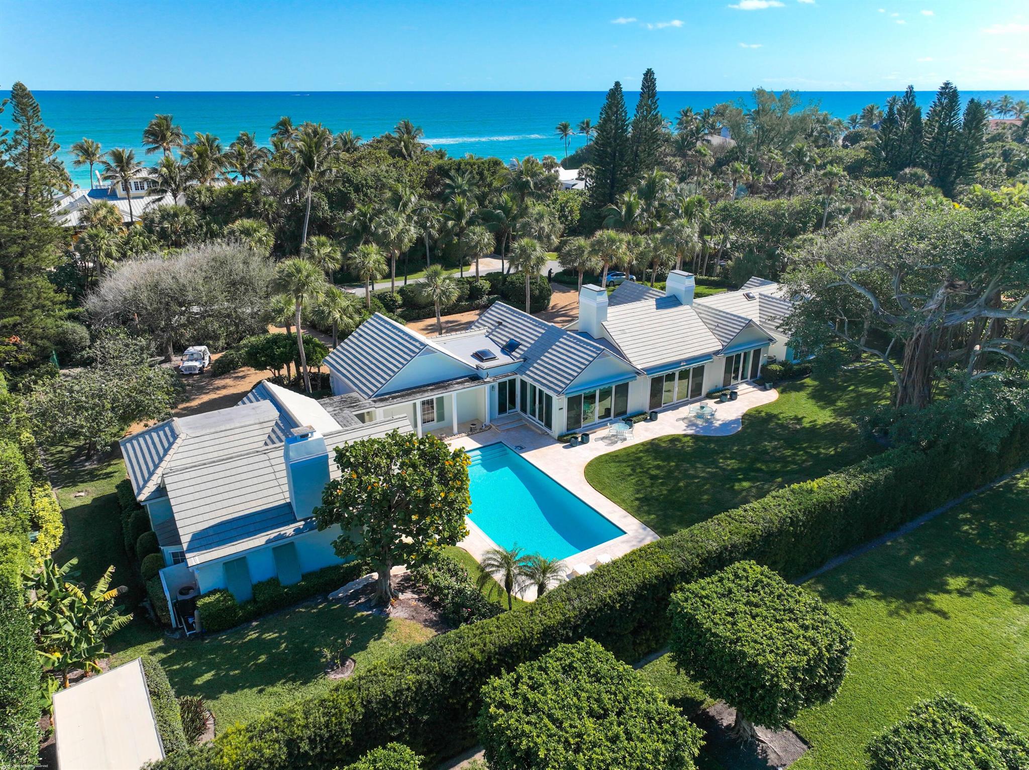 Welcome to beautiful, elegant 162 S Beach Rd. in the heart of Jupiter Island and only steps away from the pristine, white sand beach. This classic Bermuda design house sits on 3/4 OF AN ACRE and includes a main house with 3 large bedrooms plus a spacious separate office. Outdoor terraces connect the main house and pool to the 2 bedroom, 2 bath guest cottage that was built in 1993 and features a large living room and full kitchen. Old growth trees and lush landscaping provide complete and natural privacy.