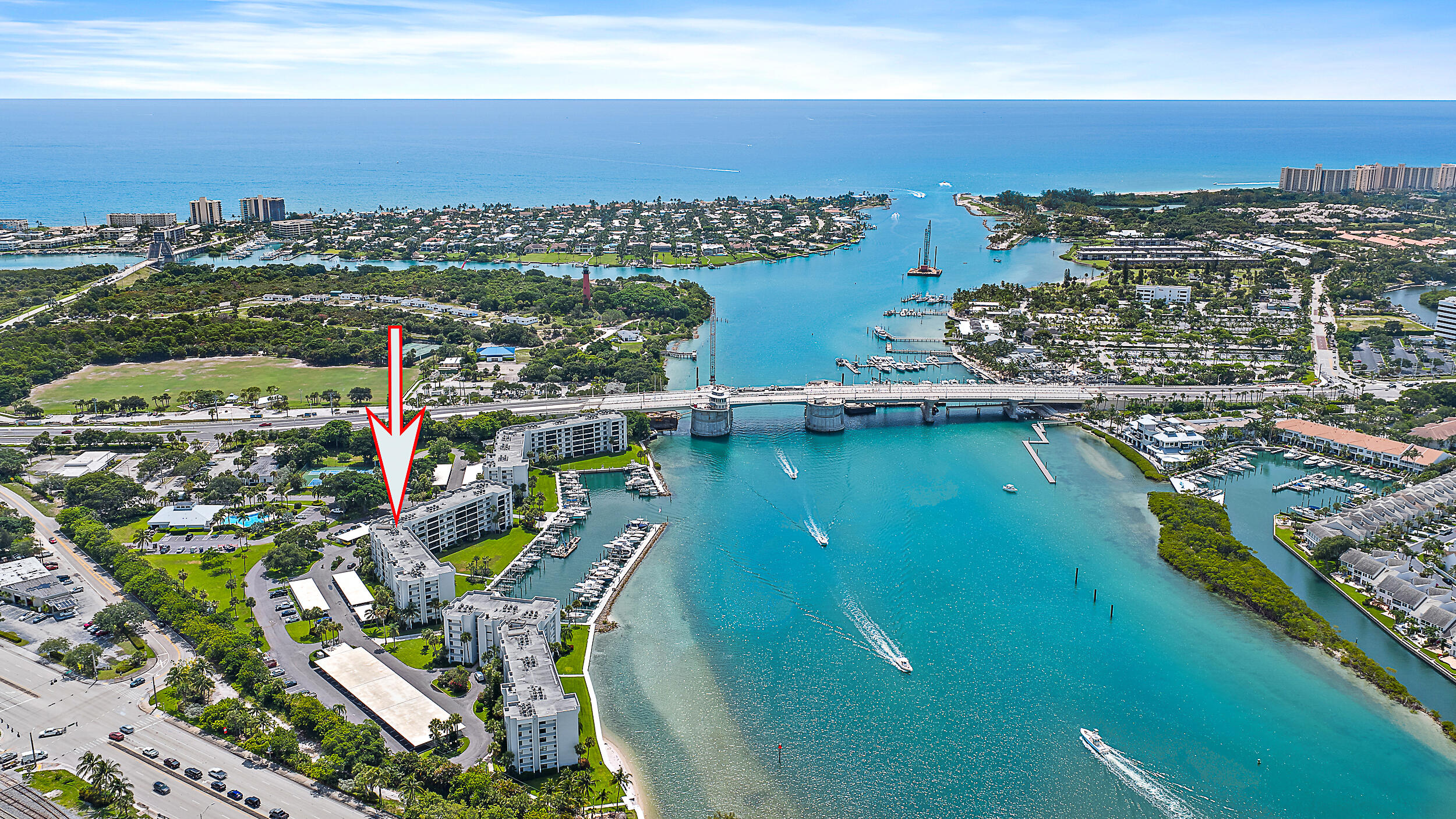 Unobstructed blue water view and deeded boat slip A4. This end unit has flex room can be den or bedroom + overlooks blue waters and  new bridge. Gorgeous contemporary remodeled interior with solid core doors, and Broadell fixtures. Living area is 20'' porcelain tile, 5 1/4'' baseboards, and crown molding. Truly custom kitchen solid wood cabinets matched with granite counters and stainless appliances. Both baths are Italian porcelain tile and guest has quartz counter, extended master closet. Impact glass is in hand, for contractor install. Amenities - resort pool area, tennis,  Pickleball, gym, clubhouse dining area, property manager onsite. Short distance to local hangout spots, cruise the Intracoastal or hit the ocean in mere minutes, and locally famous Tiki bar