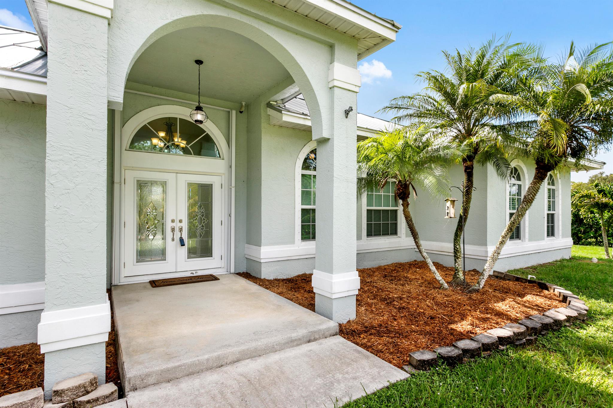 If you're looking for an amazing Key West style pool home, look no further than this stunning house with a den. Located on paved road ,1.39  acres fully fenced with huge privacy hedge and Generac full house auto generator. Not only are the windows, sliders and doors impact but there's also accordian shutters. This amazing home features tiled floors in the living area and Aqua Guard laminate flooring in all 3 bedrooms and den. the kitchen features Frigidaire stainless appliances , breakfast nook and breakfast bar.  Main bedroom has his/her walk in closets and bathroom has his/hers vanity and separate soaking tub. Guest bedrooms are generously sized. Utility room has newer top load W/D ,and shelving. Step outside to your private oasis with a kids playset and pool. Metal roof 2021. Security