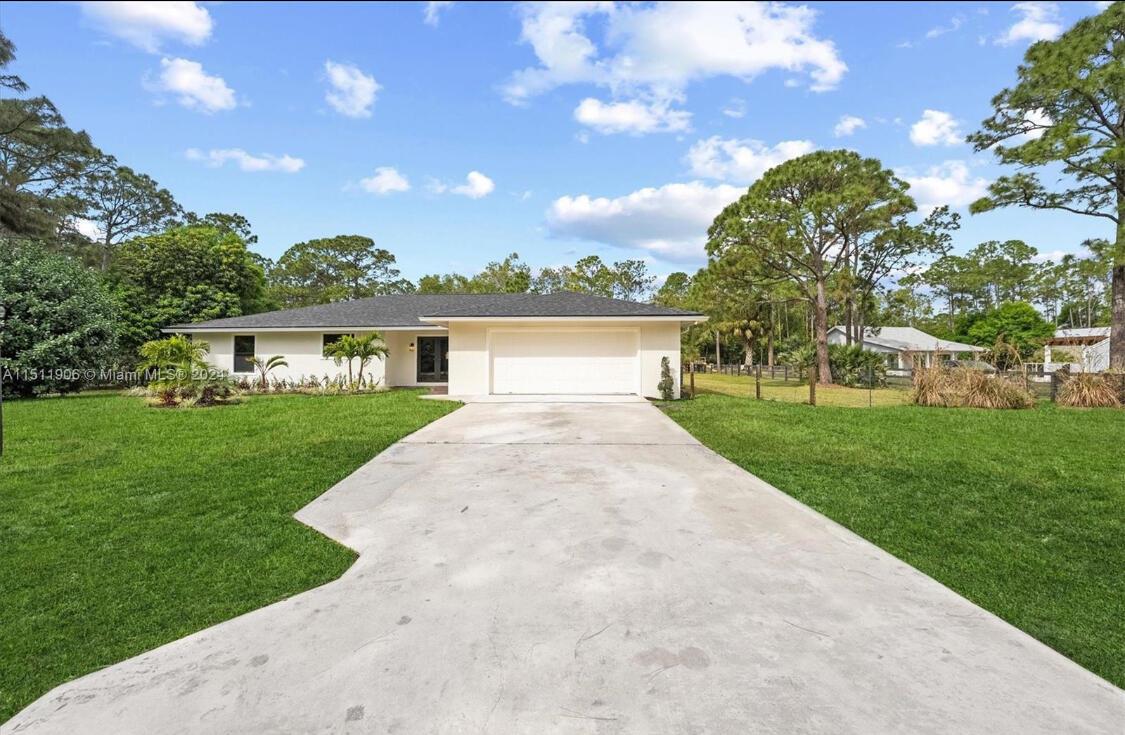 Welcome to this fully renovated oasis in the heart of Jupiter Farms! Nestled on 1.35 acres, this stunning 5-bedroom, 2 1/2 bath pool home with a 2-car garage has been completely transformed with upgrades from top to bottom! Everything is NEW--including the Roof(2023), two A/C units (2024), and full-impact windows and doors. Step into the beautifully redesigned modern home with an abundance of natural light. Featuring new wood-style flooring, new baseboards, fresh paint, and custom lighting throughout the home. The kitchen is a dream with white shaker cabinets, gleaming quartz countertops, stainless steel appliances, and reverse osmosis drinking water from the brand-new water filtration system. All the bathrooms have been luxuriously updatedwith high-end vanities, flooring,