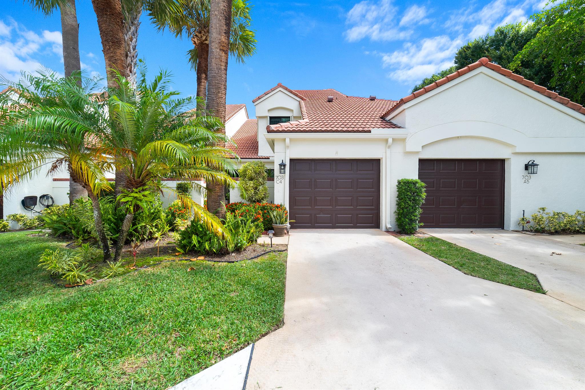 This beautifully maintained and thoughtfully upgraded residence offers a bright, open interior with vaulted ceilings, plantation shutters, and porcelain tile flooring throughout the main level, complemented by new carpet upstairs. A complete home renovation in 2016 included new light fixtures, ceiling fans, and the removal of polybutylene piping and the original water heater. The spacious layout features lofty two-story main-level living. Entry through the private courtyard which leads to an open floor plan that flows seamlessly to the rear screened patio and pool area with a privacy wall--ideal for both relaxing and entertaining. Additional upgrades include a new HVAC system (2021), an updated electrical panel with main breaker and surge protection, and surge protection at the electric meter (2022), an Ecobee smart thermostat, and garage enhancements such as pull-down stairs, overhead storage, shelving, and a new opener. Safety features include complete hurricane impact windows. A second layer of protection includes accordion shutters on the second floor, Lexan panels on the first floor, Kevlar drop-down shades for the patio and a hurricane panel for the front door. Gutters and downspouts have been added for proper drainage, along with leaf guards on the rear patio. Both bathrooms feature water-saving commodes. The HOA/POA includes cable, pest control, quarterly power washing, lawn and landscaping, building and hurricane insurance, roof and exterior maintenance, and access to the clubhouse, tennis courts, and a newly renovated pool. Located across from the Loggerhead Marine Life Center and Loggerhead Park, with the Juno Dunes Nature Area as your neighbor, this home offers low-maintenance living with coastal charm and exceptional community amenities.