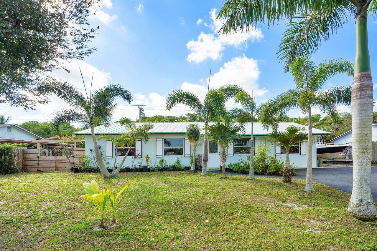 Nature Lover's Paradise on Jones Creek Preserve Discover your dream waterfront retreat in Jupiter, where tropical living meets modern convenience. Ocean access, Intracoastal access and Just 5 minutes from the beach.  This exceptional property is nestled along the serene Jones Creek Preserve, offering breathtaking views and unparalleled access to South Florida's tropical waters. With just three bridges to the ocean and 30 minutes by boat to the Jupiter Inlet, this home is a haven for nature enthusiasts and water lovers alike. Outdoor Features That Inspire:  Permitted Kayak Launch & Step-Down Dock (2013): Easily embark on water adventures with multiple access points and a thoughtfully designed dock. 
" Quaint BBQ Area, Fire Pit, &amp; Room for a Pool: Host gatherings, relax under the stars, or design your dream outdoor oasis.
" Screened Patio with Bar &amp; Outdoor Shower: Perfect for entertaining or unwinding with stunning views of the preserve.
" Orchid Hut &amp; Fully Fenced Yard: Ideal for gardening, kids, or pets to enjoy.
" 10-Year Canal Contract: Ensures Jones Creek remains clean and navigable for years to come.
" RV &amp; Boat Storage: Ample space for your toys to enhance your lifestyle.
Home Highlights:
This charming 3-bedroom, 2-bathroom home has been thoughtfully updated with features that enhance both comfort and style:
"  New kitchen cabinets: Fresh modern look
" New Bathrooms: Sleek, modern finishes add elegance.
" Impact Windows: For security, energy efficiency, and storm protection.
" Crown Moulding, Tile, &amp; Wood Flooring: Timeless finishes throughout.
" Custom Built-ins, Including Master Bed: Stylish and functional storage solutions.
" Energy-Efficient Upgrades: Newer insulation and a modern AC (2017) keep energy costs low.
" Upgraded Electrical Panel with Surge Protector: Added reliability and peace of mind.
Additional Perks:
" Long-Lasting Metal Roof (2005): Built for durability and longevity.
" Permitted Shed (2013): Versatile space for tools or hobbies.
" Not in a Flood Zone: Providing cost savings and security.
" Walking Distance to All Schools: A convenient location for families.
This home combines the tranquility of life along Jones Creek Preserve with the convenience of being minutes from Jupiter's best beaches and tropical waters. Whether kayaking through scenic canals, gathering around the fire pit, or designing your dream pool, this property is your gateway to the ultimate Florida lifestyle.
Schedule your private showing today and seize this extraordinary opportunity!