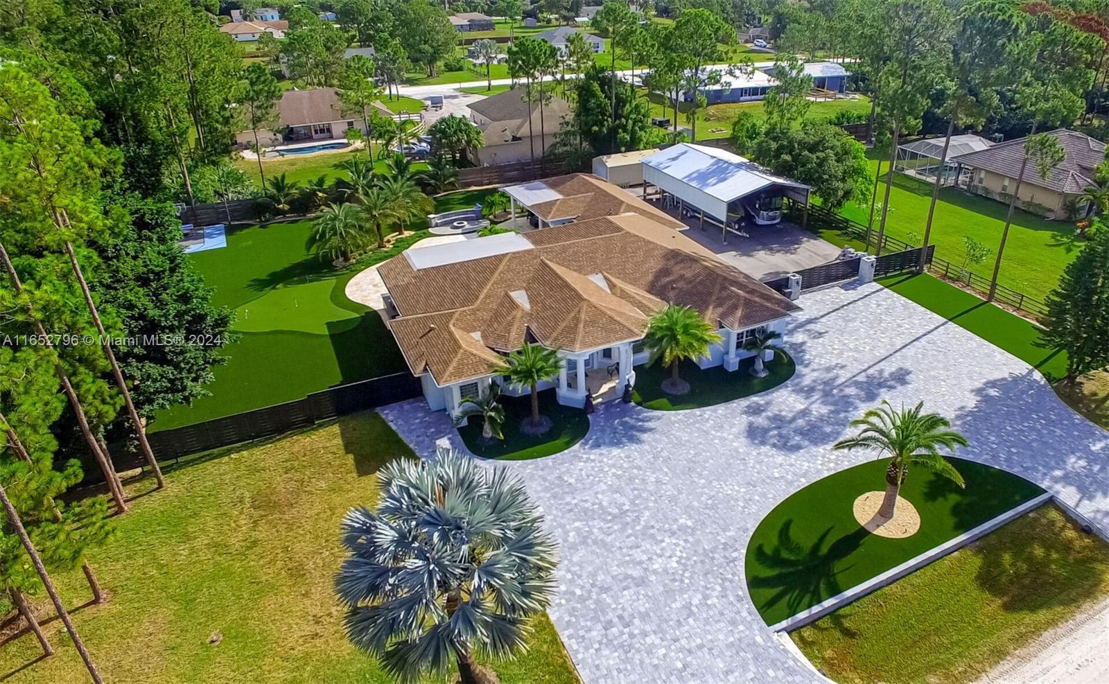 THIS IS YOUR DREAM HOME. This breath-taking, state of the art residence is paradise on earth. The property sits in 1.15 acres of land and it's located only minutes from Northlake Blvd, Westlake and Royal Palm Beach. This beautiful 5 bedroom home with attached guest house creates a spacious, and bright living feel. The kitchen has luxurious custom built handleless cabinets, quartz countertops and backsplash, large island with waterfall edge, built in refrigerator and pantry. Wolf stainless steel appliances. The master bedroom suite has panoramic views of the pool and backyard, two walk-in closets, and a spacious master bathroom with a roman tub, separate shower, and double sink vanity. The house also features a 2 car garage with glossy epoxy. Ready to move in.