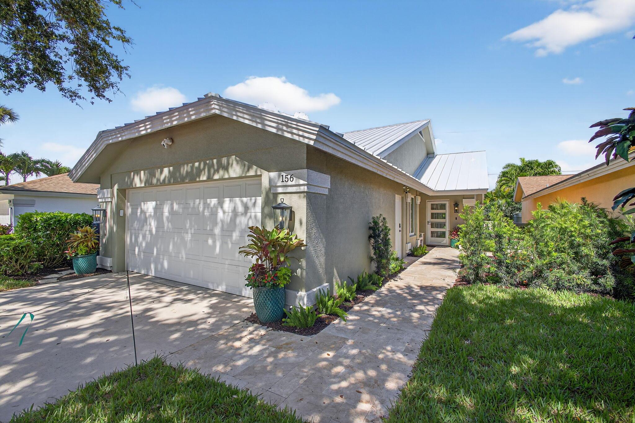 Impeccable 3-Bedroom, 2-Bath Home in The Bluffs - Just Steps from the Beach!  Located in the highly sought-after, pet-friendly community of The Bluffs Ridge, this beautifully renovated single-family home is the ultimate beachside retreat--just a short walk to the ocean.  No detail has been overlooked in this thoughtfully updated residence. Inside, you'll find wide plank tile flooring throughout the main living areas, new carpet in all bedrooms, elegant Serena & Lily light fixtures, all-new baseboards and trim, updated interior doors, and a fresh, cohesive aesthetic that blends coastal style with modern comfort.  The chef-inspired kitchen features premium appliances, including a Liebher refrigerator, KitchenAid induction stove, and dishwasher&#x14;perfect for entertaining or everyday living.
The spacious primary suite is a serene haven with a luxurious en-suite bathroom offering dual sinks and an oversized walk-in shower. Both bathrooms have been tastefully updated to reflect a spa-like ambiance.
Enjoy year-round peace of mind and efficiency with all-new hurricane-impact windows and doors, a new metal roof, a 2021 AC unit, and a 2025 tankless water heater. The home's exterior has been freshly landscaped and includes a new covered back patio with a stylish shiplap ceiling and recessed lighting&#x14;ideal for outdoor dining or relaxing after a beach day. An outdoor shower adds a practical and charming beachside touch.
This move-in-ready gem offers the perfect blend of refined interiors and coastal living in one of Jupiter's most desirable communities.