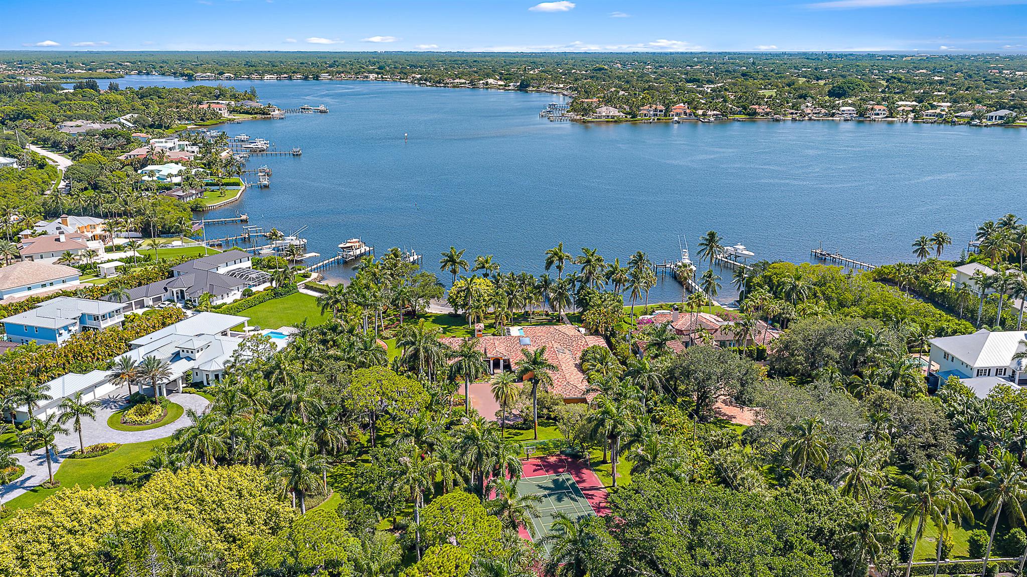 Set on over 2.5 acres with approximately 200 feet of direct riverfront, this is one of the most extraordinary properties ever offered on prestigious Pennock Point. Enjoy panoramic views of the Loxahatchee River from a homesite enveloped in mature, tropical landscaping offering unmatched privacy and a natural, estate-like setting that's increasingly rare in South Florida. Whether you choose to build a legacy residence, explore subdivision opportunities, or move into the existing home, the possibilities are endless. Pennock Point is one of Florida's most desirable waterfront enclaves, known for its expansive lots, peaceful riverfront lifestyle, and close proximity to everything Jupiter has to offer including some of the finest golf courses in the country. Top-ranked clubs like The Bear's Club, Jupiter Hills, and Apogee are a quick drive away, making this an ideal location for golf enthusiasts who also want to enjoy life on the water. Dock your boat in the backyard and cruise the scenic Loxahatchee, head out to the ocean, or stop at Jupiter's top waterfront restaurants. This is South Florida living at its finest! Jupiter offers something for everyone. Enjoy miles of unspoiled beaches, scenic nature trails, world-class dining, boutique shopping, vibrant local arts, and top-rated schools all just minutes away. Whether you're raising a family, entertaining guests, working remotely, or simply seeking a peaceful retreat, this location offers the perfect blend of luxury, convenience, and South Florida charm.