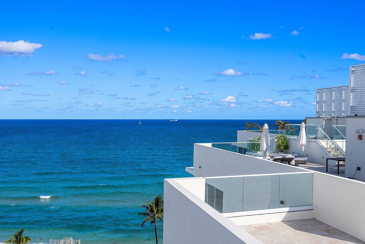 This ultra private, oceanfront penthouse featuring its own 3,000 sq ft rooftop terrace is located at 3550 S Ocean, a luxury development of 30 condos newly constructed in 2019. Featuring 2 en suite bedrooms and a den with office space (could be converted to a third bedroom) and 3rd guest bathroom. It is offered tastefully furnished in a palette of natural hues and includes automatic window shades in all rooms and windows. Open kitchen concept with unique architectural island, Miele appliances and gas range. All 3 bathrooms feature custom vanities with recessed lighting! Private elevator access to your own rooftop terrace with elevated spa tub overlooking both the ocean and the intracoastal, perfect for entertaining. 2 car covered parking with motorized lift system. Building offers on-site