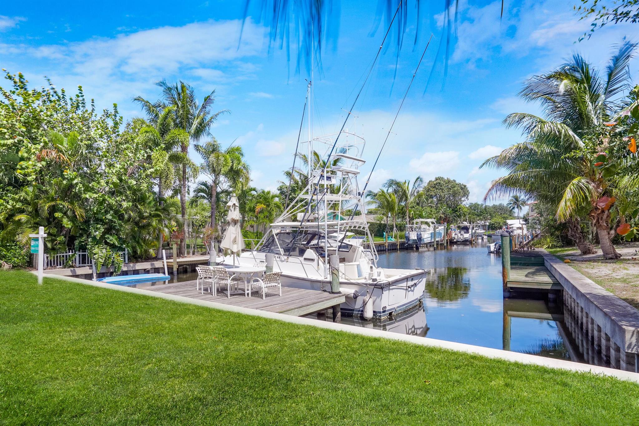 Build your dream waterfront home with intracoastal and ocean access and no fixed bridges. This unique lot looks directly down the canal framed by Palm Trees and boats highlighting it's old Florida charm. 83' of waterfront with private dock that can accommodate boats up to 35'. Paradise Port is a cozy boat-friendly community with no HOA fees! Other features of the property include a well maintained seawall and room for a beautiful circular driveway. AC is not working in Duplex. Minutes to everything Juno Beach, Jupiter and downtown Palm Beach Gardens has to offer. Minutes to 1-95 and 25 minutes from PBI airport - this is the boaters paradise location you've been dreaming of. Walking &/or  distance to the beach, restaurants.