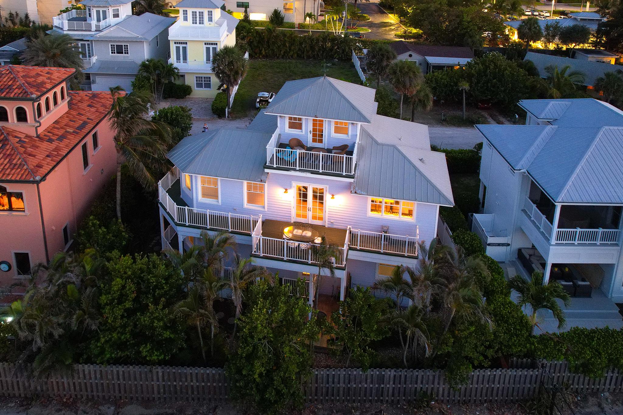 Introducing your perfect coastal haven, a remarkable three-story retreat that doubles as a highly profitable AirBnB. Prepare to be captivated by this stunning abode, offering an extraordinary layout and mesmerizing ocean vistas from every angle. The first floor graciously welcomes your guests with a comfortable guest bedroom and a full bath, ensuring their privacy and contentment. The primary room is thoughtfully positioned on this level, providing easy access to the outdoors through an ensuite bath--an exceptional blend of convenience and tranquility. Ascending to the second floor, you'll discover a generous living area, a well-appointed kitchen, and an inviting dining space. Complete with an additional guest bedroom and a full bath, this floor guarantees ample accommodation options. However, the true pi+¿ce de r+¬sistance awaits beyond the French doors...an expansive balcony beckoning you to immerse yourself in breathtaking ocean panoramas.  Venture up to the third floor, where a versatile flex room awaits, ready to adapt to your desires. Whether you seek a serene yoga retreat, a creative art studio, an inspiring home office, or an extra guest bedroom, this space is limited only by your imagination. Sunlight streams in from windows facing the north, south, and east, bathing the room in warm natural light and offering sweeping ocean views.  This Key West-inspired sanctuary features a durable metal roof, wraparound balconies, and lush papaya and mango trees, imbuing your surroundings with a tropical essence. And the icing on the cake? You'll relish being just steps away from the enchanting ocean, granting you the privilege to bask in the sun, inhale the invigorating sea breeze, and forge unforgettable memories. For added convenience, a spacious owner's closet is available should you choose to continue renting the property. 
Don't miss out on this extraordinary opportunity to own a coastal retreat that effortlessly combines luxury, income potential, and an idyllic lifestyle. Seize the chance to make this dream a reality and embrace the coastal living you've always desired.