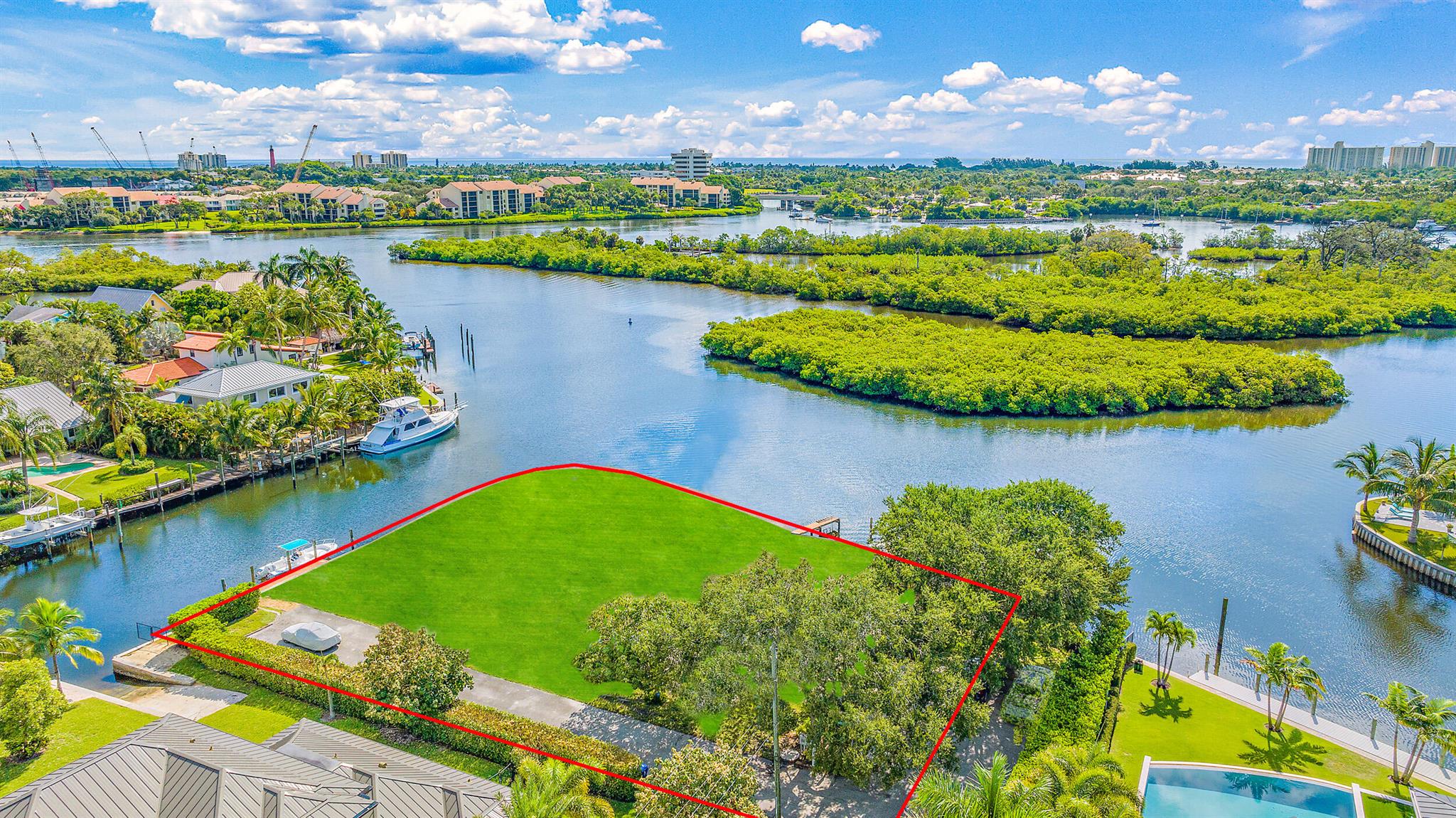 Exceptional Waterfront Opportunity East of the Brightline Corridor. This unique offering combines three separate parcels into a sprawling waterfront property, allowing for your creative vision.Situated on a generously sized corner lot, spanning approximately half an acre, this remarkable property features an impressive 300 feet of water frontage. Boasting deep water access without any fixed bridges and located to the East of the railroad tracks, it serves as an unobstructed gateway to the glistening waters of Jupiter, creating an idyllic haven for boating enthusiasts.With a picturesque vista overlooking a pristine preserve area, this lot ensures unblemished views and an ambiance of serene seclusion, making it an ideal setting for an opulent estate or a development opportunity.