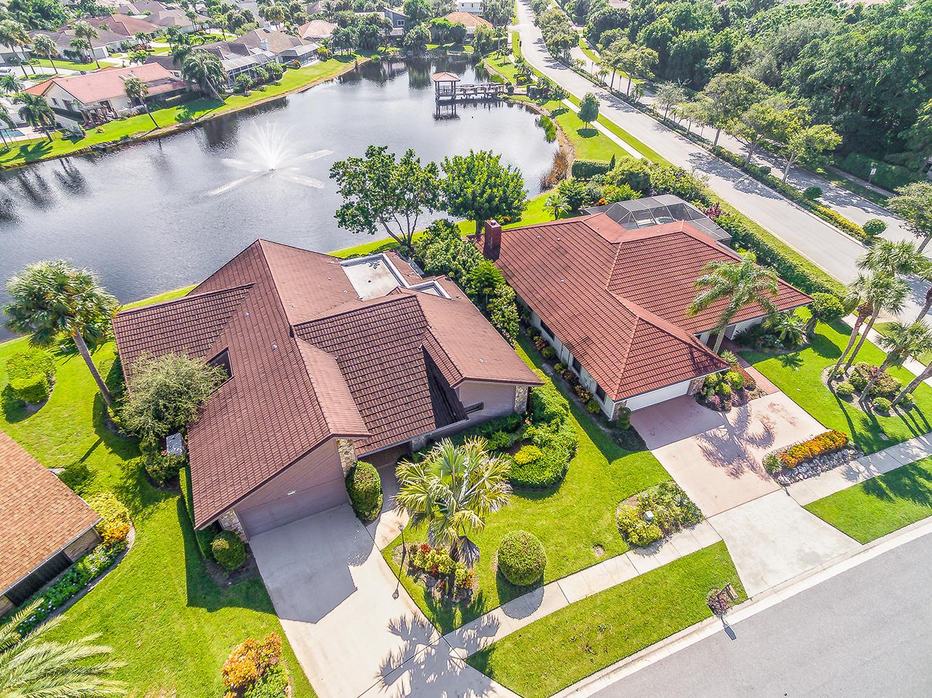 Fully renovated lakefront home in Frenchmens Landing! Open design w. volume ceiling, split 4BR/3BA! Panoramic lake &fountain view from a huge kitchen/family room combo area. This house was completely renovated by a renowned interior designer in 2019, resulting in a stunning contemporary look. All new kitchen featuring white cabinets, 2 large islands (one double level), high end stainless steel appliances, glass tile backsplash, Italian granite countertops & state of the art touchtone induction cooktop.  New porcelain tile floors throughout  provide the  look of white marble w/ gray veins. Large wall in the family room newly paneled w/ porcelain tile provides a perfect background for a flat screen LED TV &a 7 foot long built-in LED fireplace.  New ceiling fans in all rooms incl. Florida rm New HVAC units and compressors. Whole house generator provides peace of mind regardless of the weather. New Venetian blinds and motorized, remotely controlled solar shades throughout the house. Water view through french doors from Master suite with double walk in closet. Master bath has spa tub and separate shower as well as double vanity sinks. Large laundry room w/ W/D and sink. 2 car garage. Professionally and tropically landscaped (enjoy your very own banana grove and a mature avocado tree in your backyard).  So close to tennis courts, basketball and playground. LOW HOA! with no restrictions on number or size of pets. Minutes to downtown restaurants and entertainment, shopping, medical facilities and beaches!  
The beach is within a three minute drive or a leisurely bike ride. Or just relax on the back patio in the shade of your avocado tree, tranquilized by the serenity of the lake and the fountain. And when it's time to travel - the airport is only 20 minutes away.