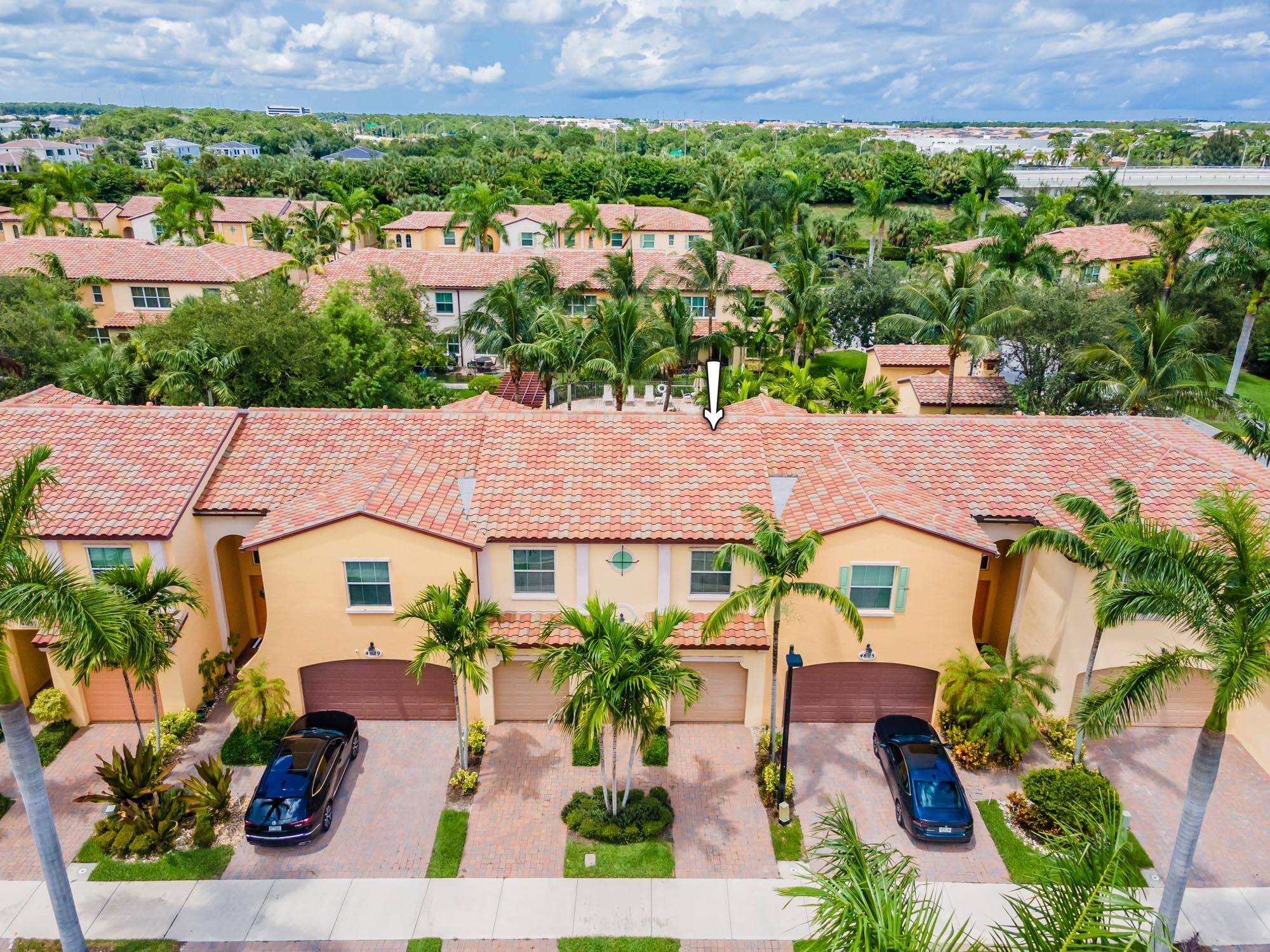 Discover the essence of luxury living in this exceptional townhome situated within the prestigious gated community of Trevi at the Gardens.  Designed for effortless maintenance, the low HOA fees cover essential services along with a comprehensive home security system - enhanced by 24/7 camera monitoring at the gate and across community areas, offering an extra layer of protection. Step through the threshold into an open-concept sanctuary adorned with 18x18 ceramic tile, complemented by impact windows and tasteful crown molding throughout, reflecting a blend of elegance and functionality. The heart of the home, the expansive kitchen, boasts granite countertops, decorative backsplash, stainless steel appliances, and upgraded cabinets, catering to the culinary enthusiast's inviting community pool - a scene of relaxation and joy. This remarkable home enjoys a prime placement, offering effortless access to the community's amenities, including a fitness center. Trevi at the Gardens offers an intimate community comprising 75 Mediterranean-style two-story townhouses, designed with families in mind. You're welcome to bring up to two pets to enhance your living experience. The low HOA fees include lawn care, basic cable, and internet services. Embrace the convenience of being within reach of exceptional shopping, dining, entertainment, and major highways. The prestigious Gardens Mall and the vibrant Downtown and Midtown at the Gardens are yours to explore.